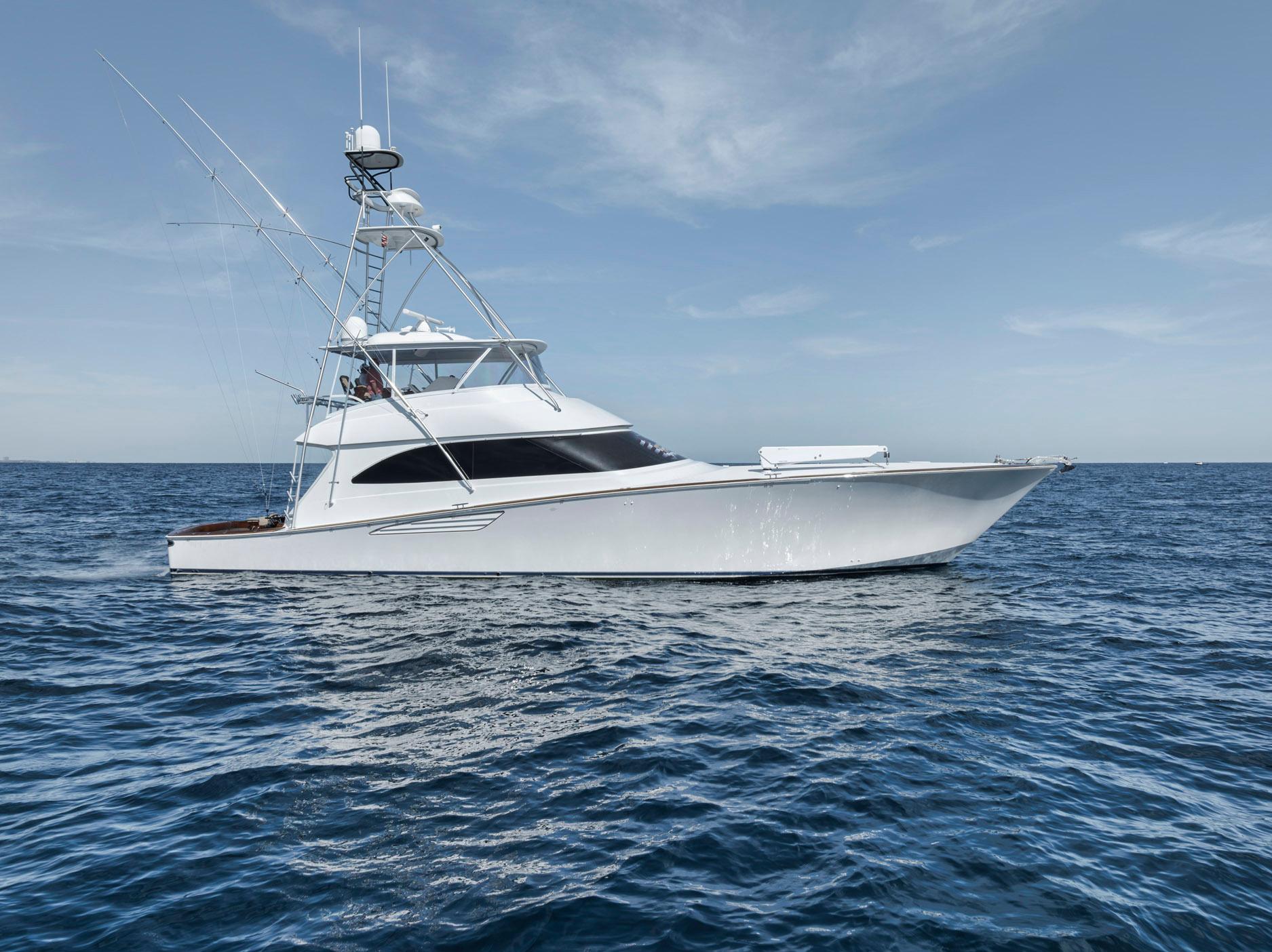 Viking 70 Convertible 2015 yacht cruising on open sea under clear sky.
