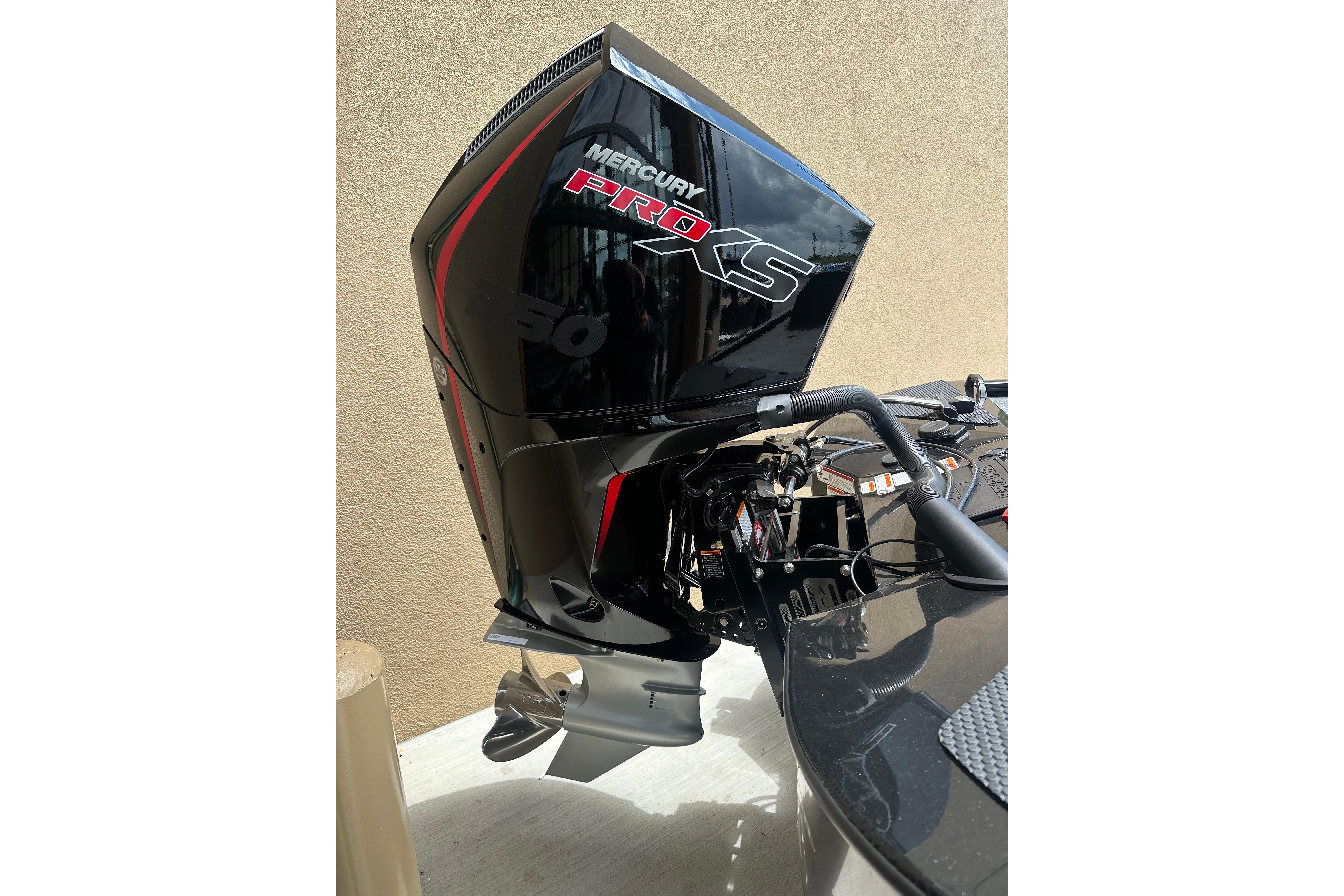 Outboard motor on 2025 Tracker Savage 215 boat, featuring Mercury Pro XS engine.