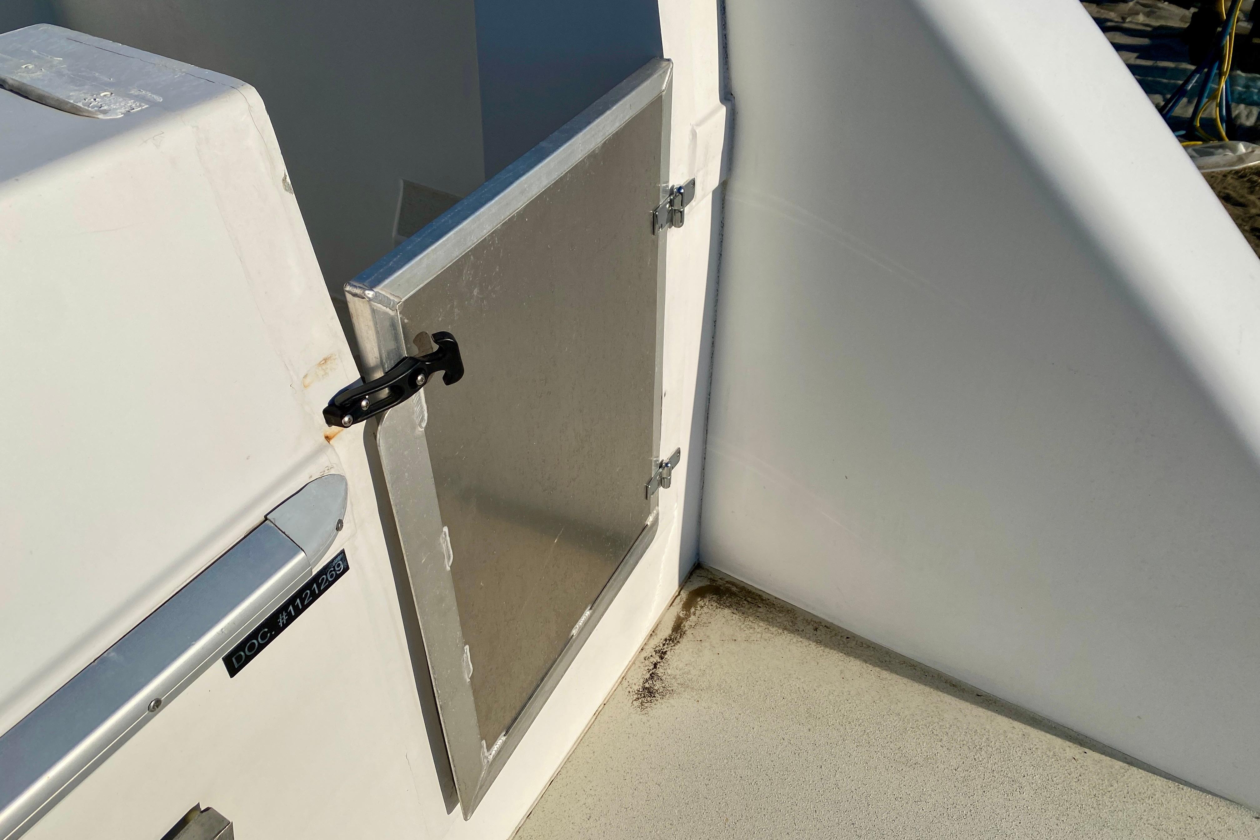 Aluminum door on 2001 SportsCat 44 boat, featuring a secure latch mechanism.