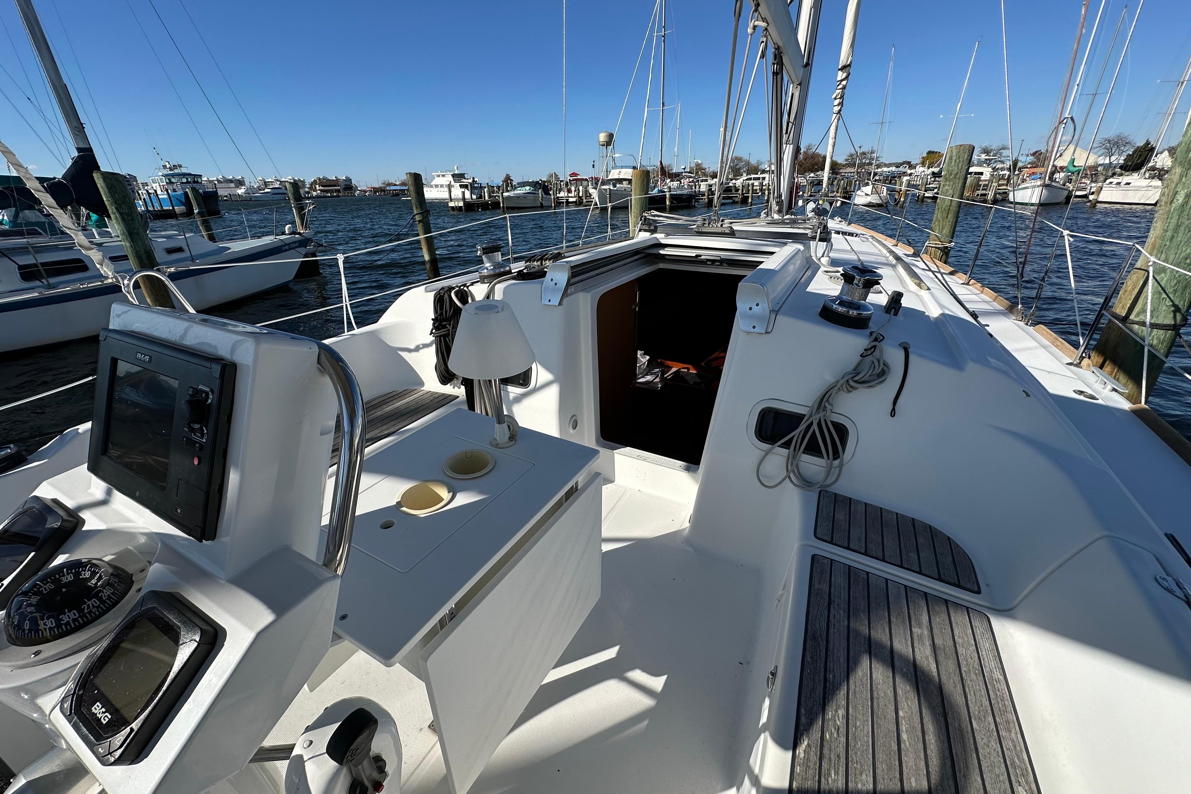 2015 Beneteau Oceanis 37 sailboat cockpit with navigation equipment, docked at marina.
