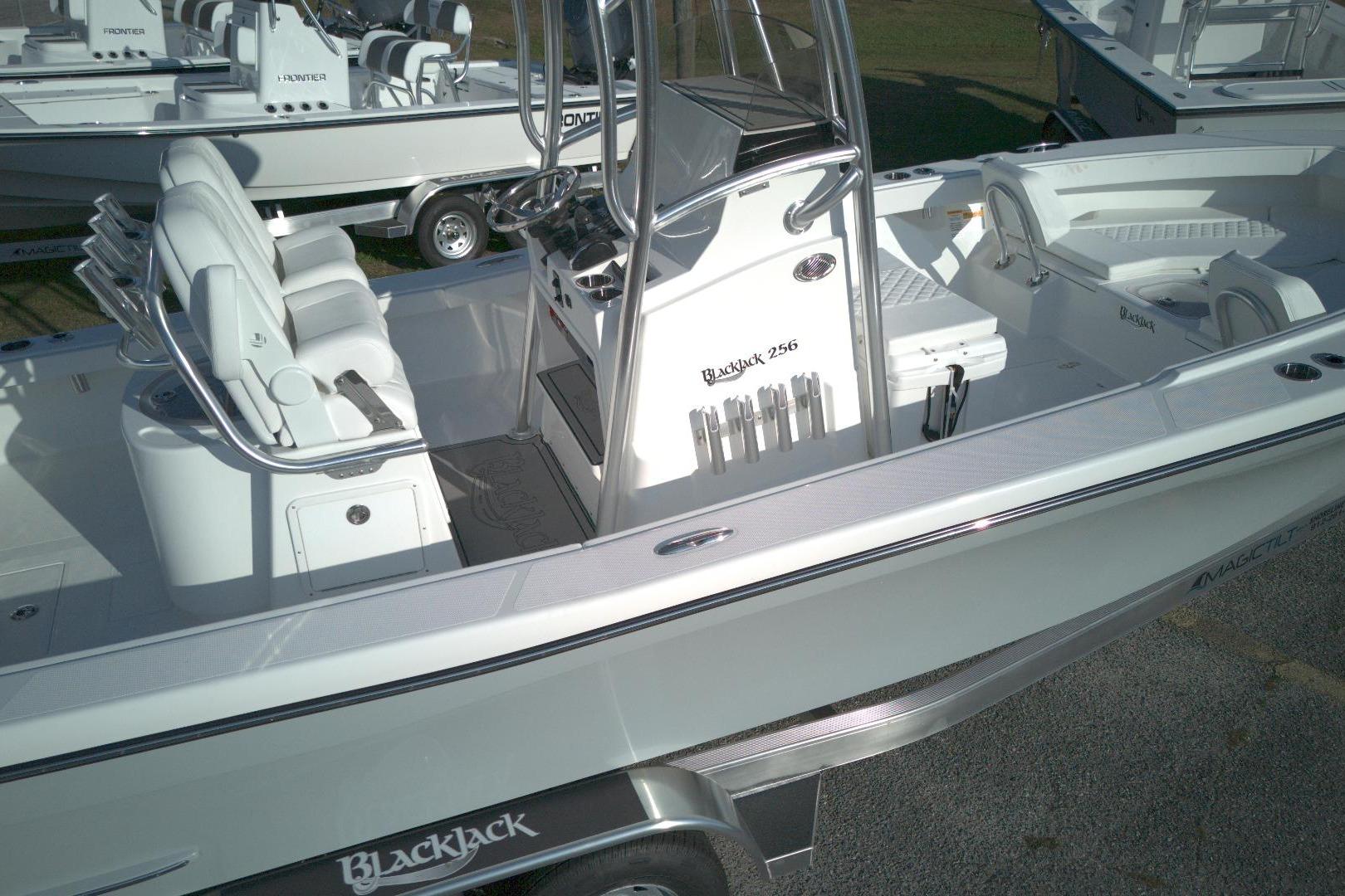 2026 BlackJack 256 Coastal boat with sleek design and modern features, docked on trailer.