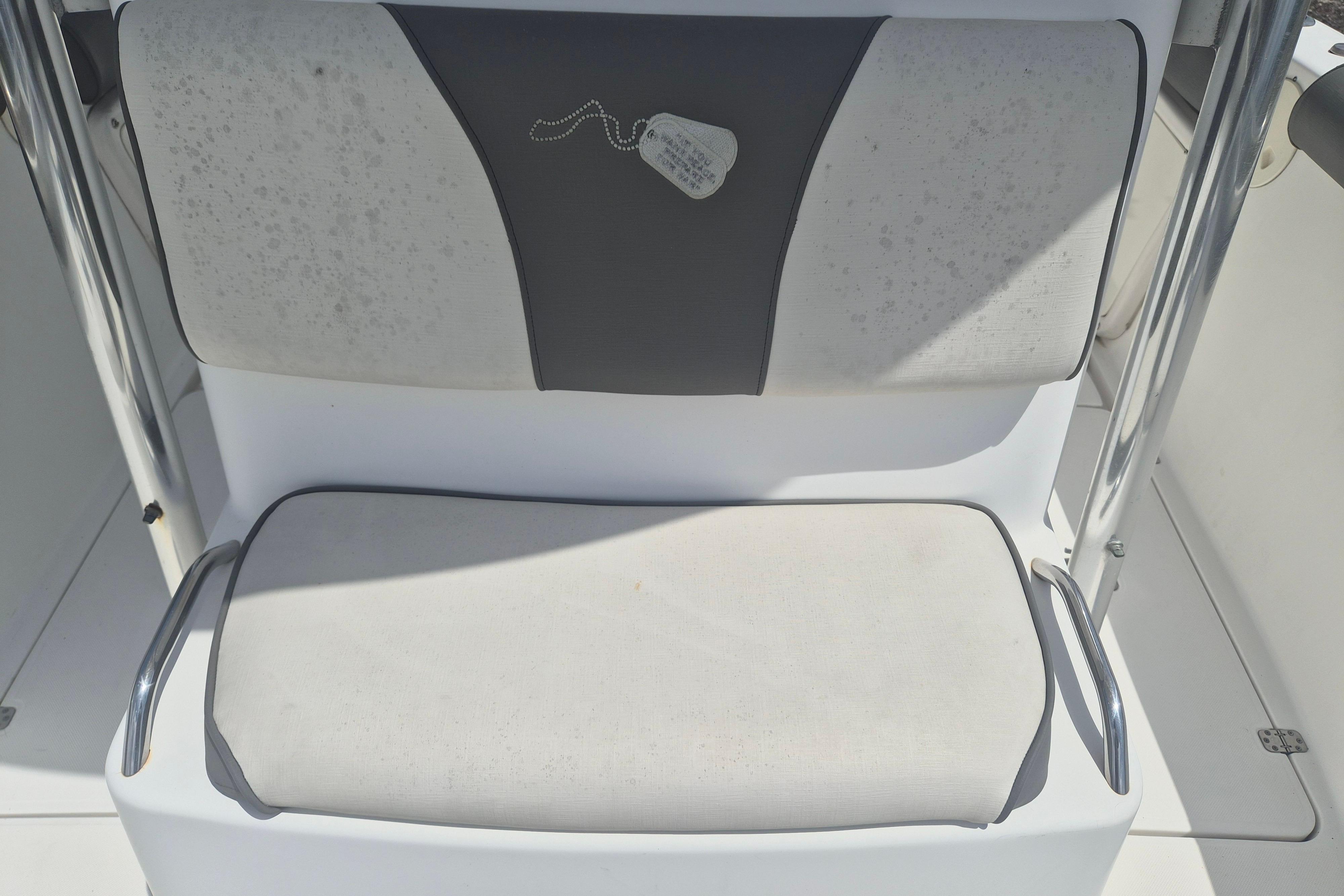 2006 Century 2900 Center Console boat seat with stainless steel armrests.