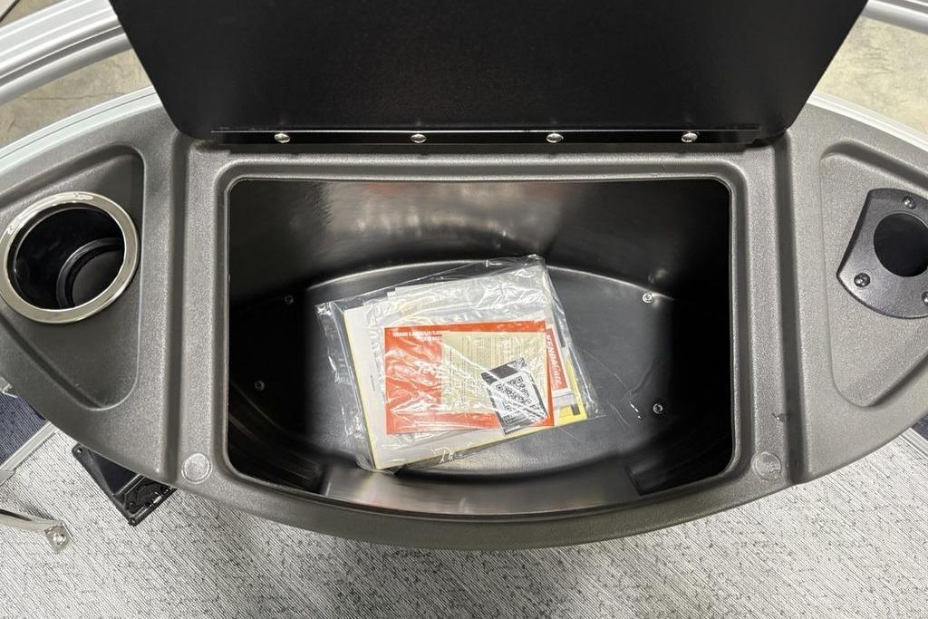 Storage compartment of 2026 Sun Tracker Bass Buggy 18 DLX with cup holders.