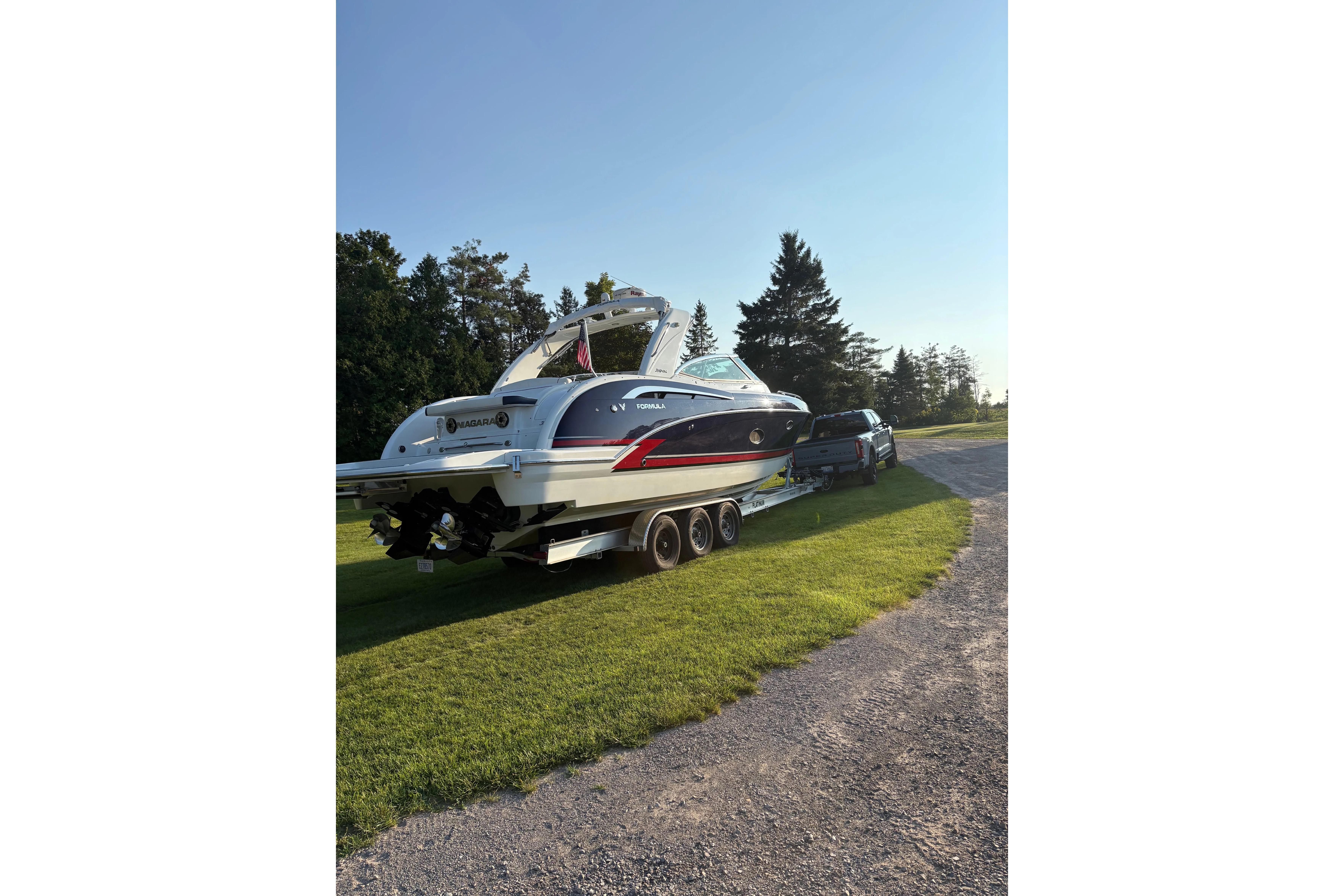 2015 Formula 350 Crossover Bowrider on trailer, parked on grass, sunny day.