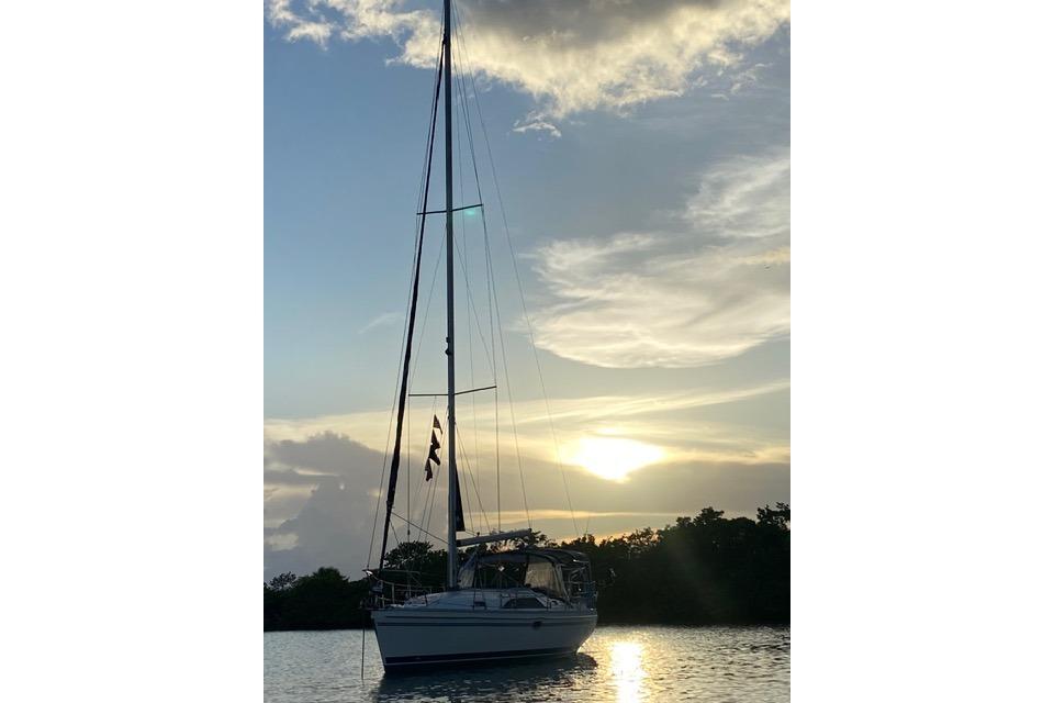 Sailboat Catalina 355 (2011) at sunset on calm water.
