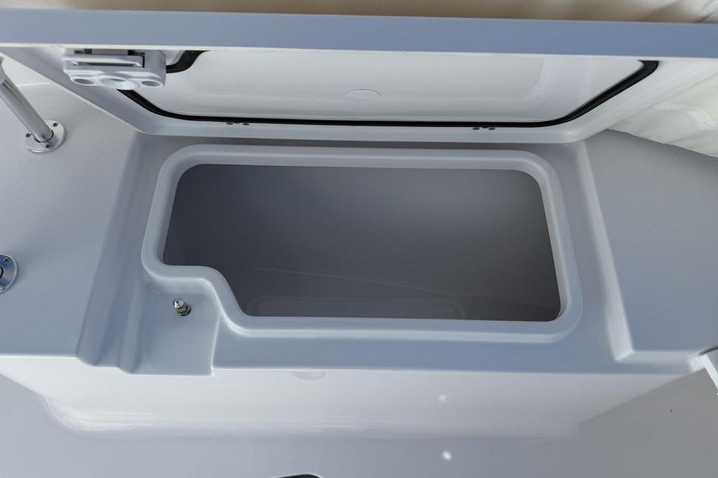 2026 Sportsman Open 232 Center Console storage compartment, open lid view.