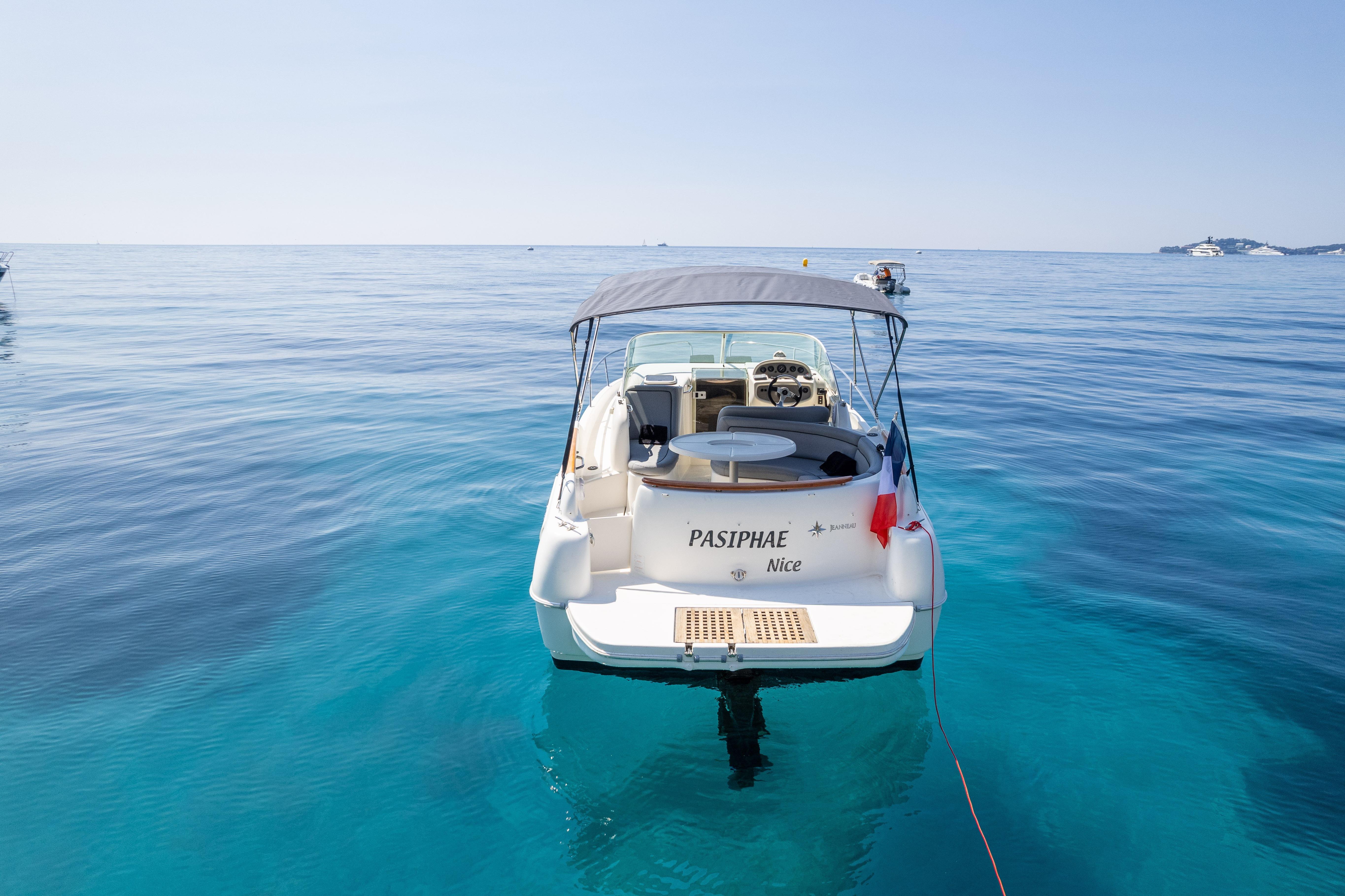 2006 Jeanneau Leader 805 boat on clear blue water, rear view with canopy and flag.