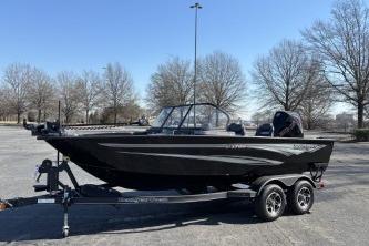 2025 Ranger VX1788 WT boat on trailer in parking lot, surrounded by trees.