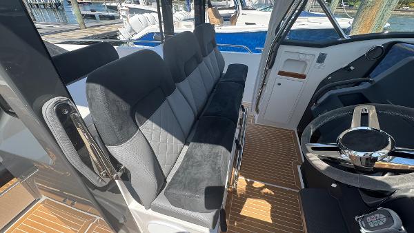 Interior of 2025 Nimbus T11 boat with plush seating and modern steering wheel.