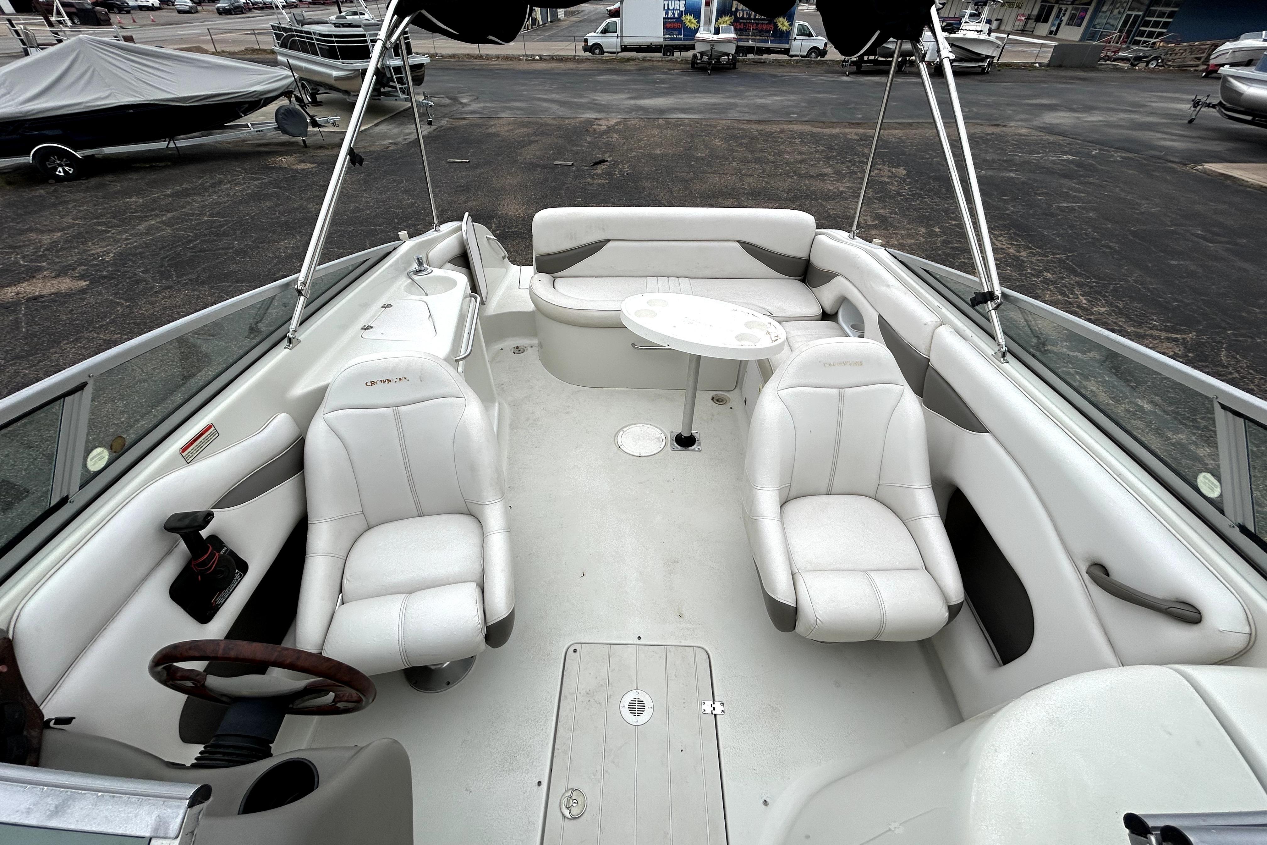 2001 Crownline 239 DB boat interior with white seating and steering wheel.