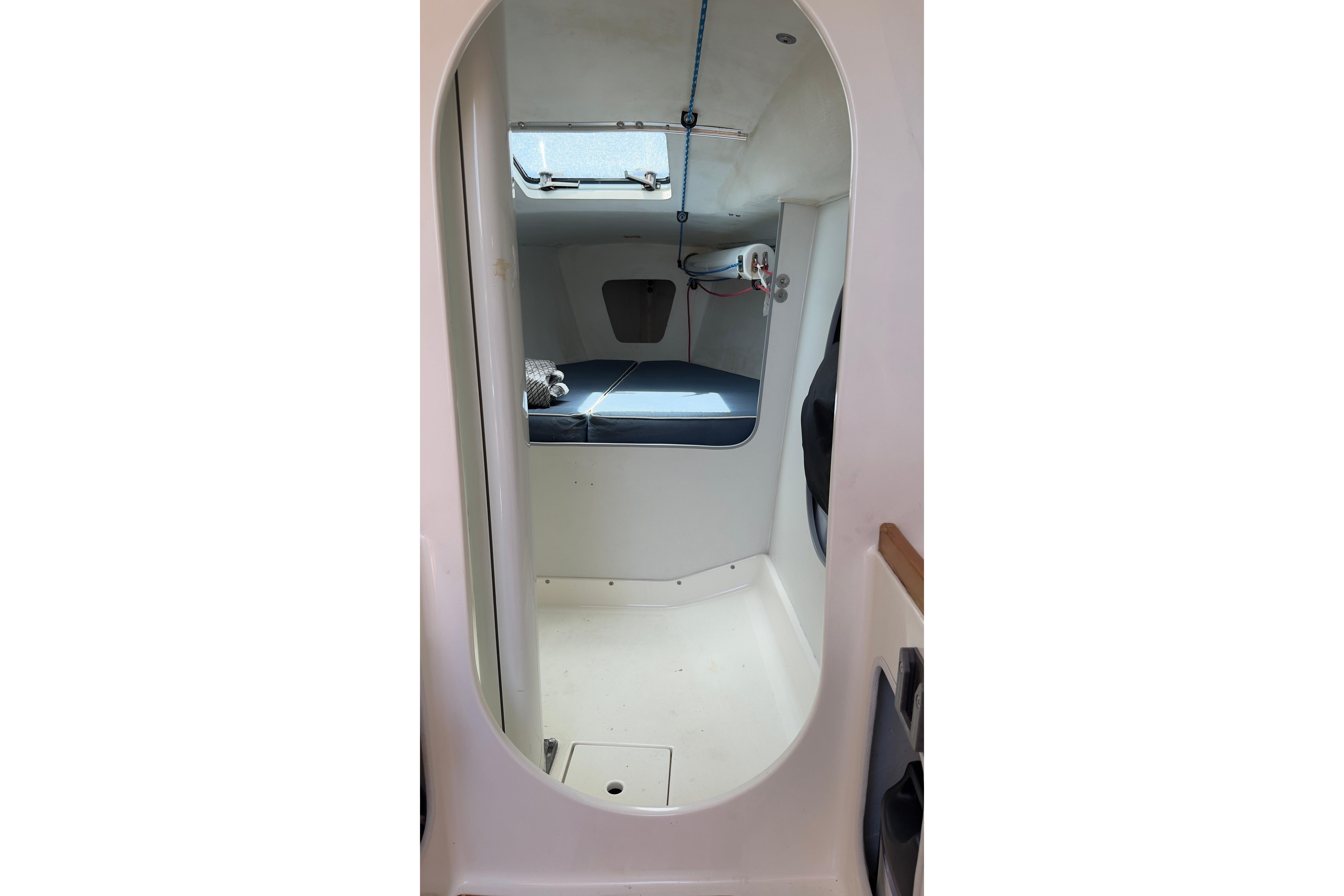 Interior cabin of a 1994 J Boats J/92 sailboat, featuring a compact sleeping area.