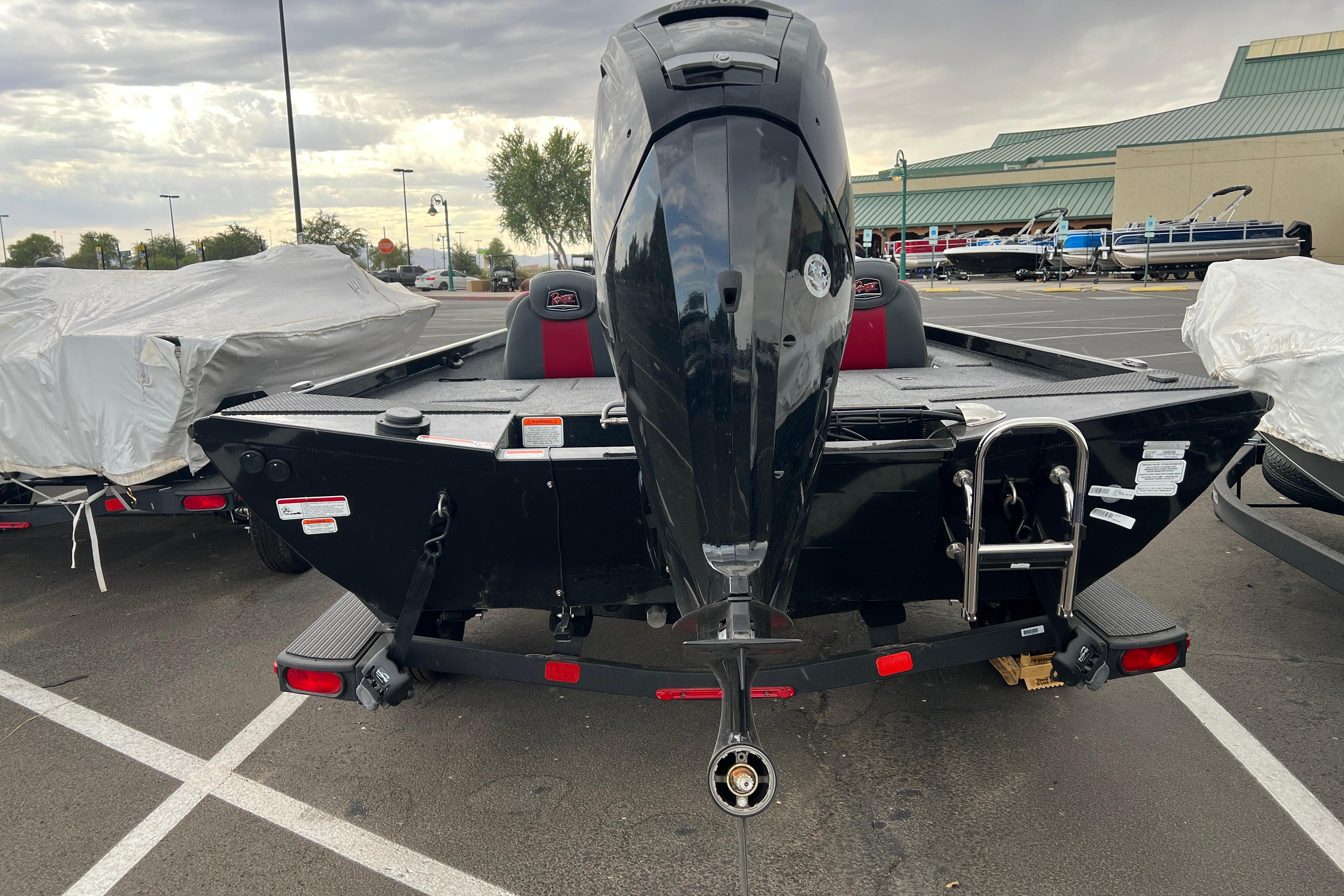 2026 Ranger RT188 boat with outboard motor in a parking lot.