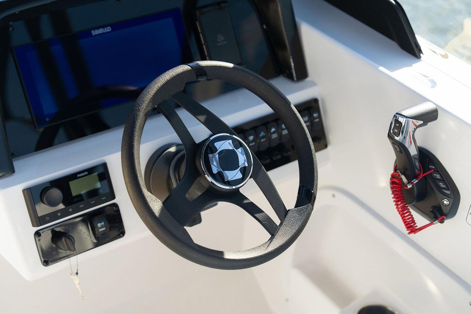 Manufacturer Provided Image: Steering wheel and controls of 2026 Stingray 20 SBX boat cockpit.