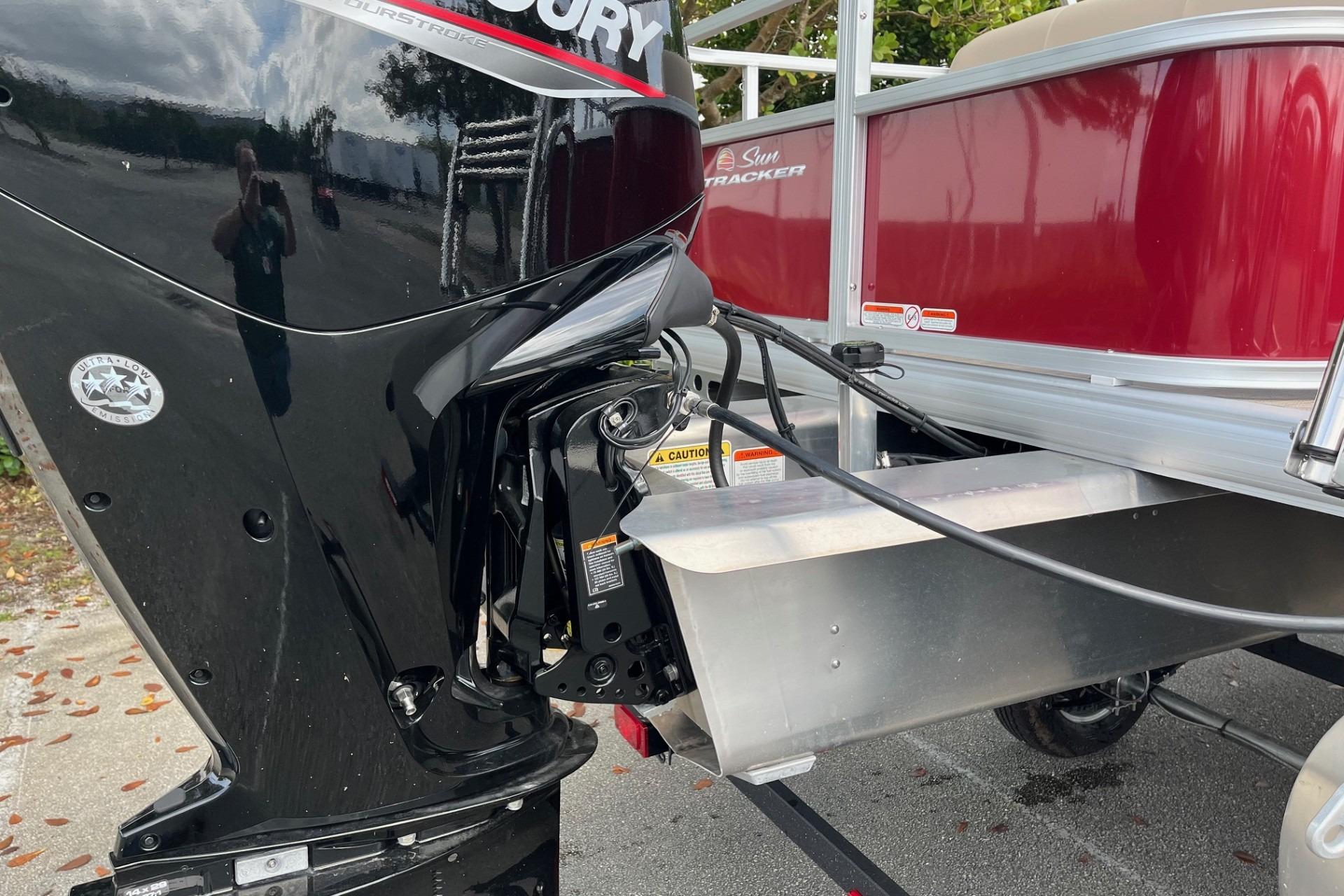2025 Sun Tracker Party Barge 18 DLX with Mercury outboard motor, side view.