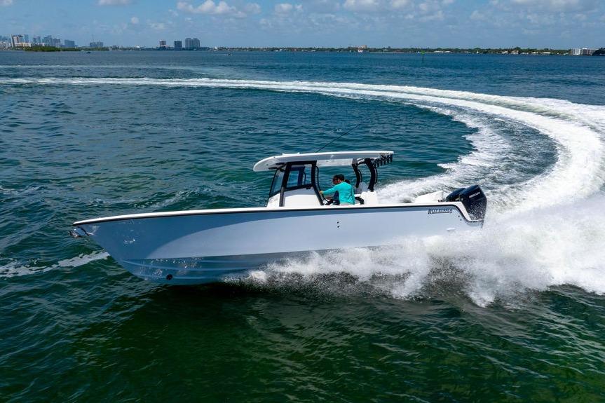 2027 Reef Runner 340 boat cruising swiftly on open water.