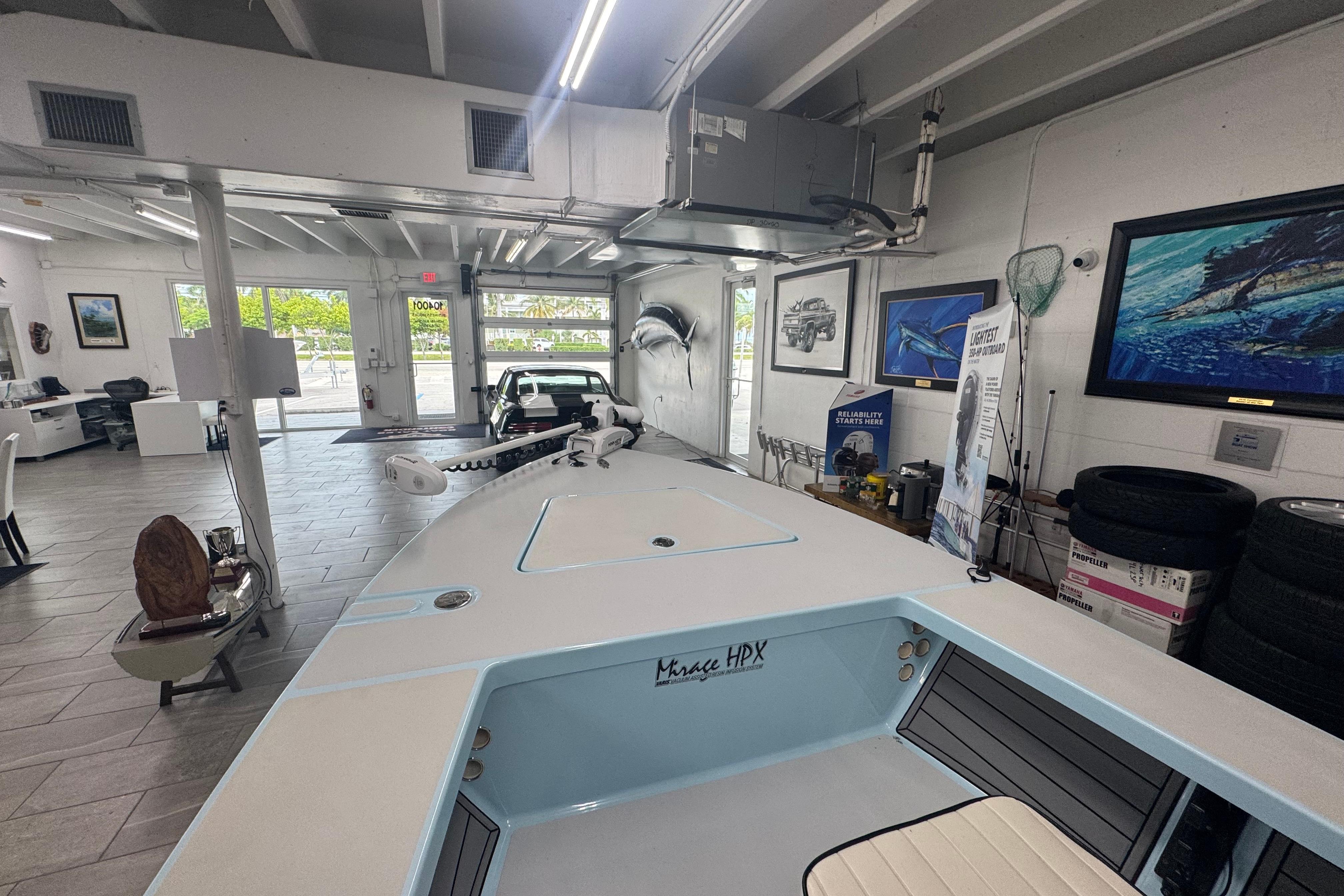 2020 Maverick Mirage 18 HPX-V boat displayed in a showroom with nautical decor.
