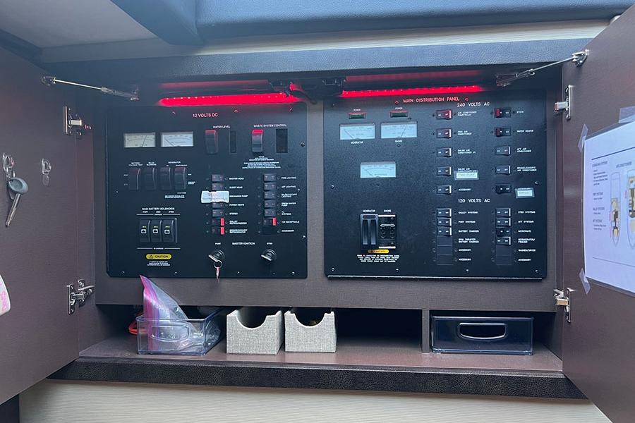Electrical control panel inside a 2015 Sea Ray 470 Sundancer yacht, featuring various switches and meters.