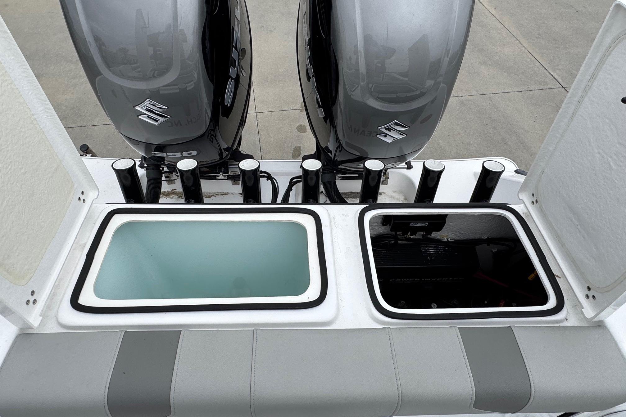 2024 Cape Horn 32 XS boat with dual Suzuki outboard motors and open storage compartments.