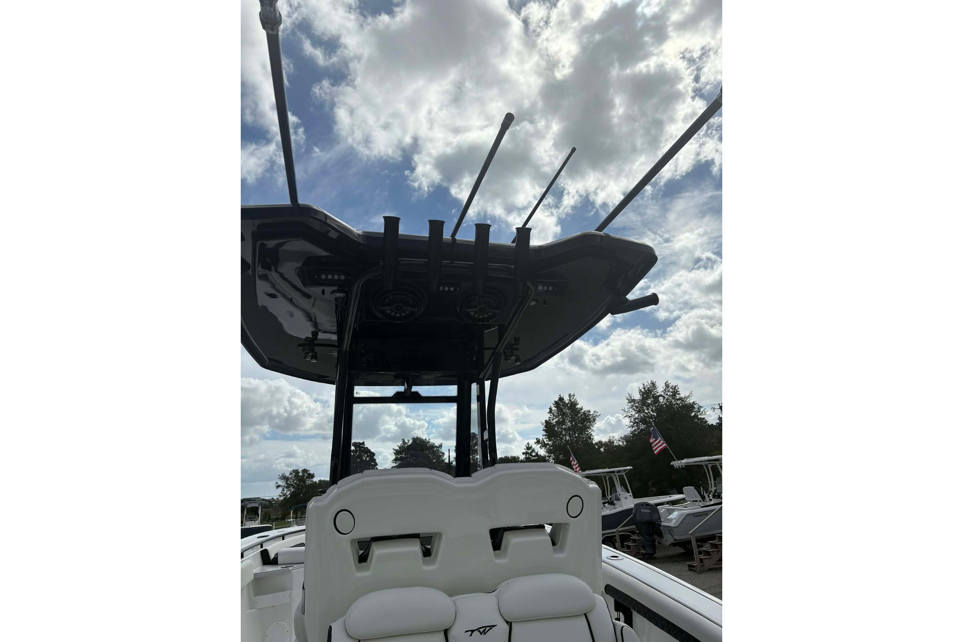 2026 Tidewater 282 CC Adventure boat with T-top against cloudy sky.