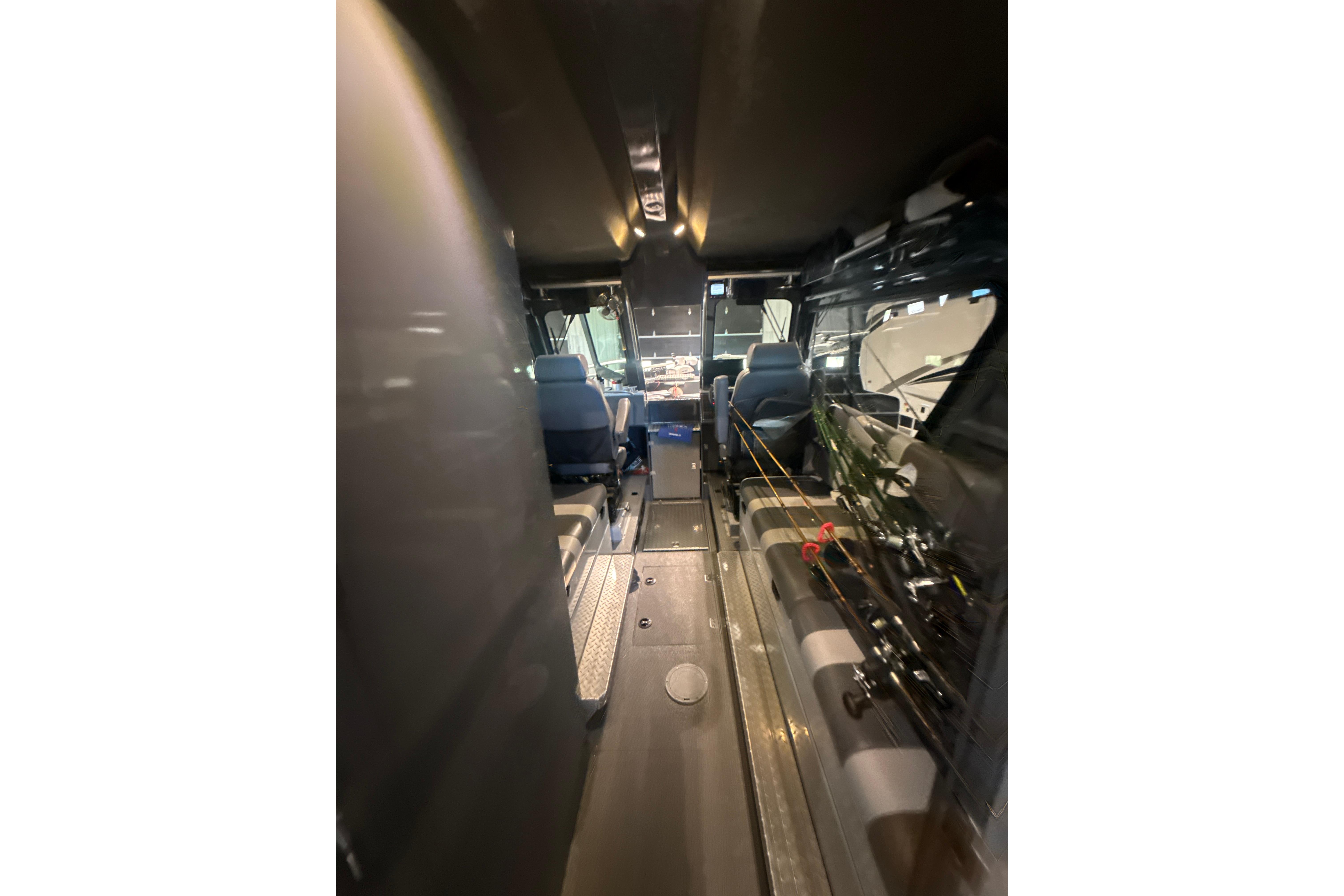 Interior view of 2022 Hewescraft 270 Alaskan Hardtop boat, showcasing seating and equipment.