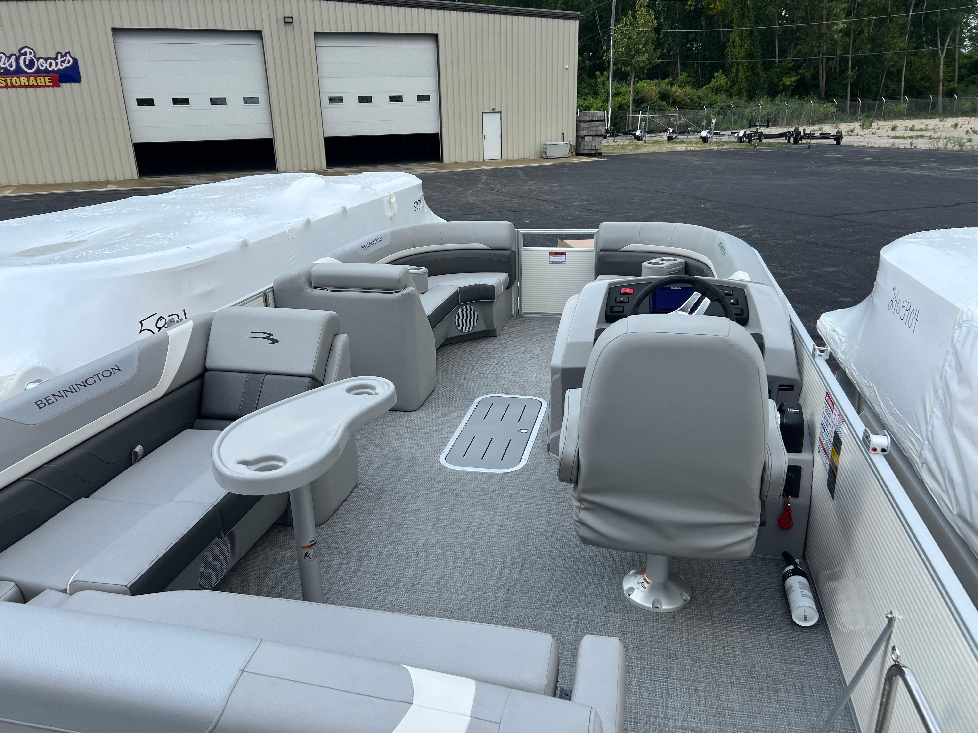2025 Bennington 21 SXSB pontoon boat interior with gray seating and helm.