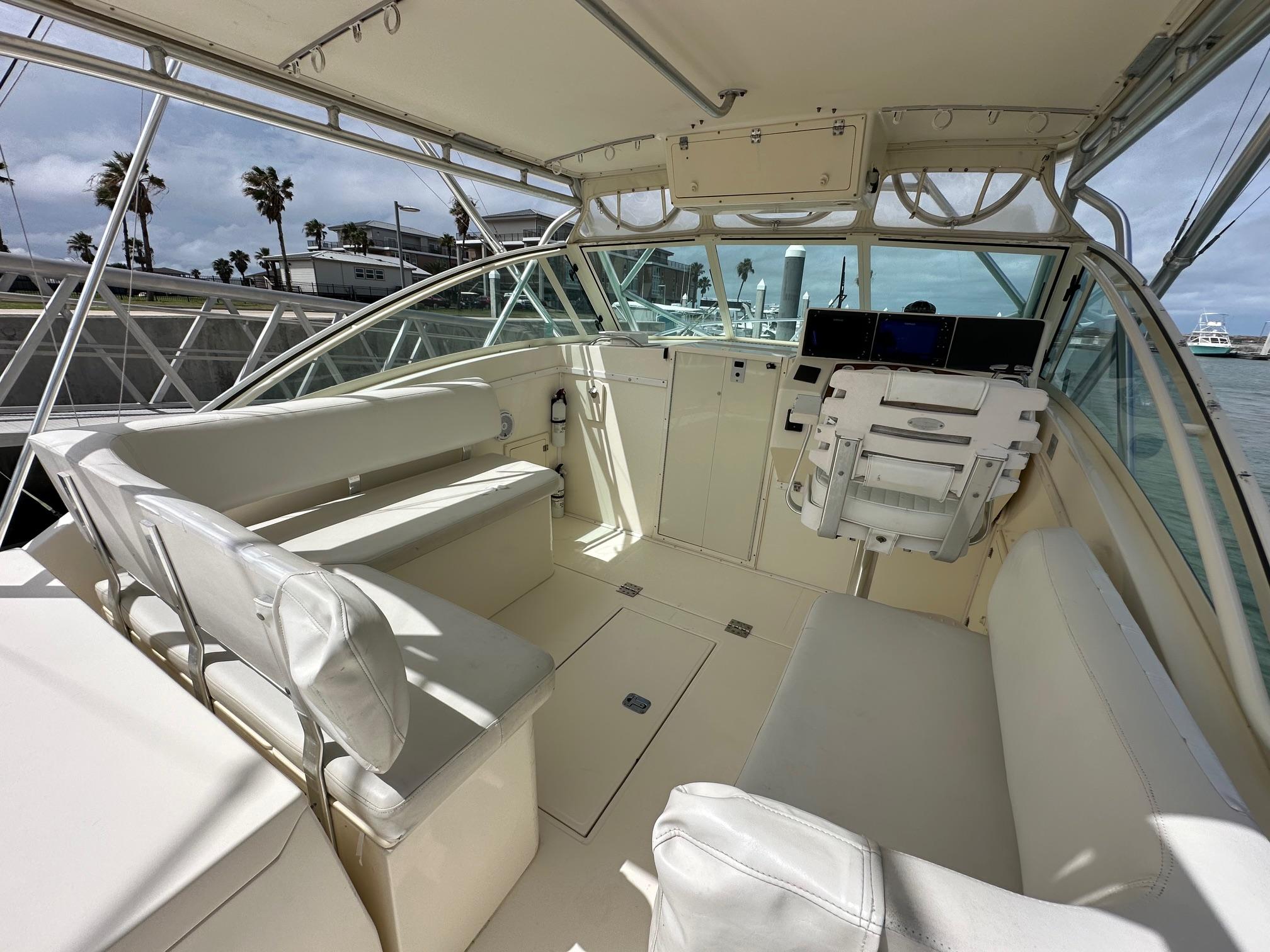 2006 Albemarle 320 Express Fisherman boat interior with seating and helm station.