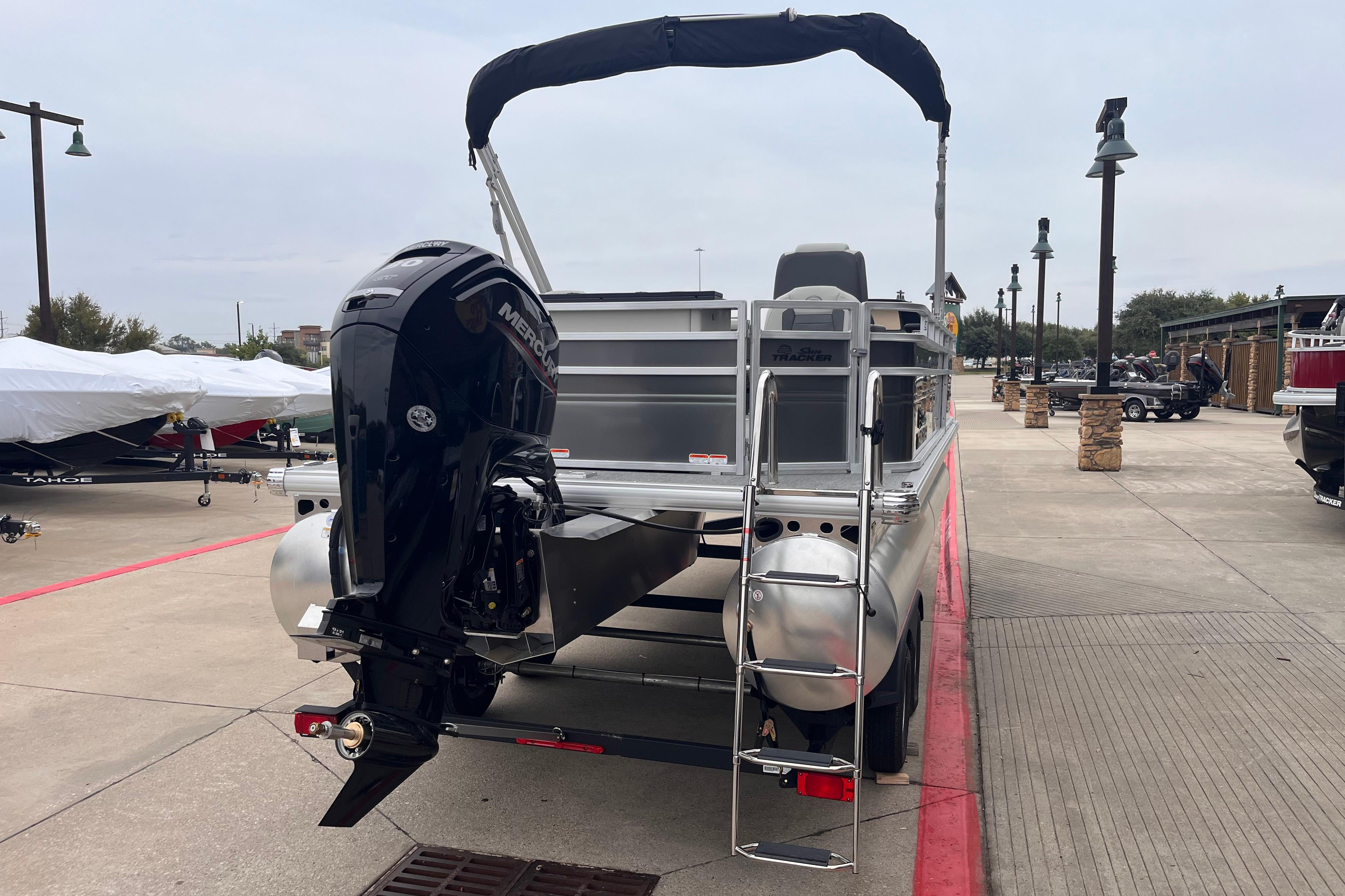 2026 Sun Tracker Fishin' Barge 20 DLX pontoon boat with Mercury outboard motor.