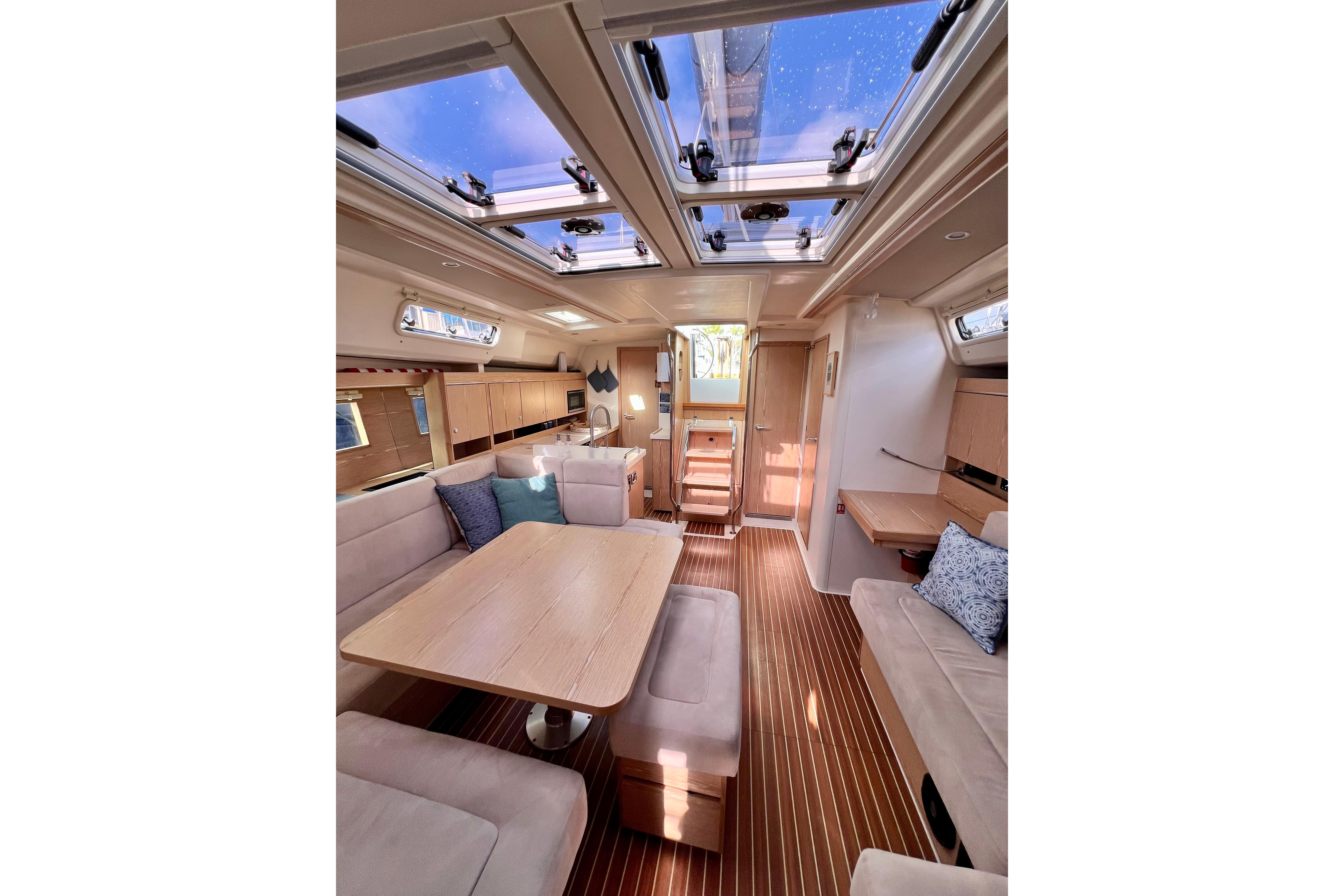 Luxurious interior of 2016 Hanse 455 yacht with skylights and elegant wood finishes.