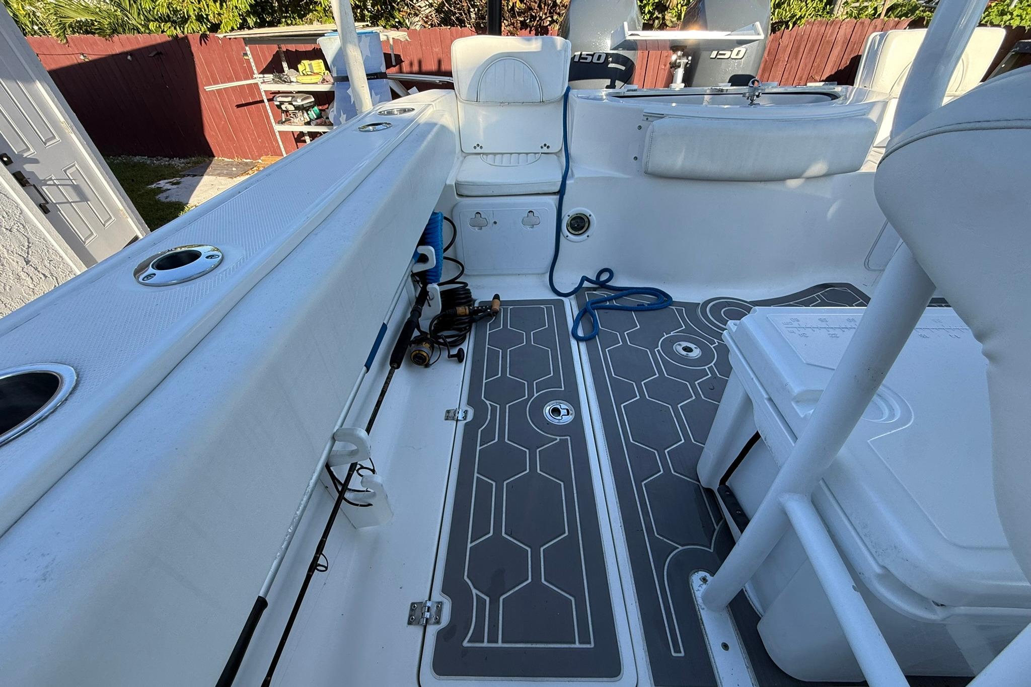 2014 Sea Fox 256 Commander boat interior with seating and fishing rod holders.