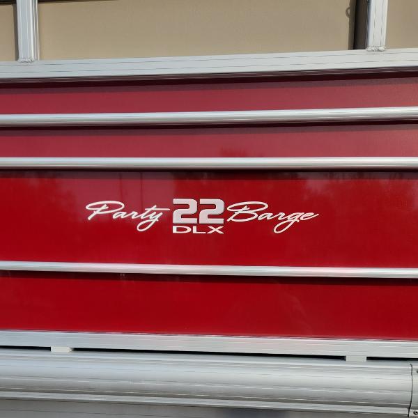 2023 Sun Tracker Party Barge 22 XP3, red exterior with DLX logo.