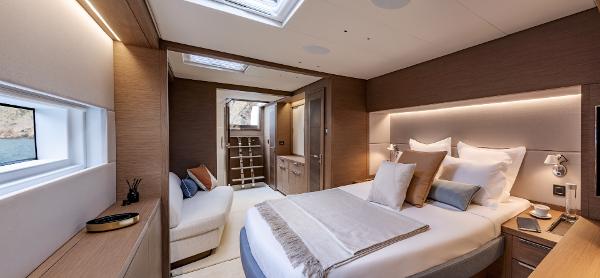 Luxurious bedroom interior of 2025 Lagoon SIXTY 7 yacht, featuring modern design and cozy ambiance.