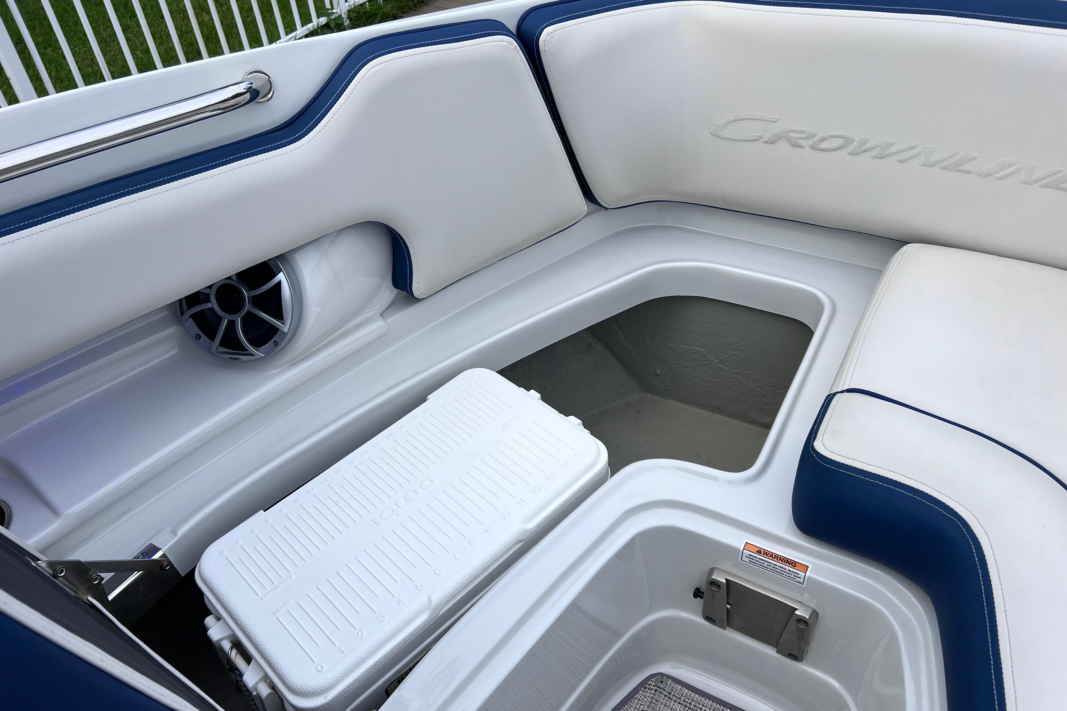 2022 Crownline 290 XSS boat interior with storage compartment and speaker.