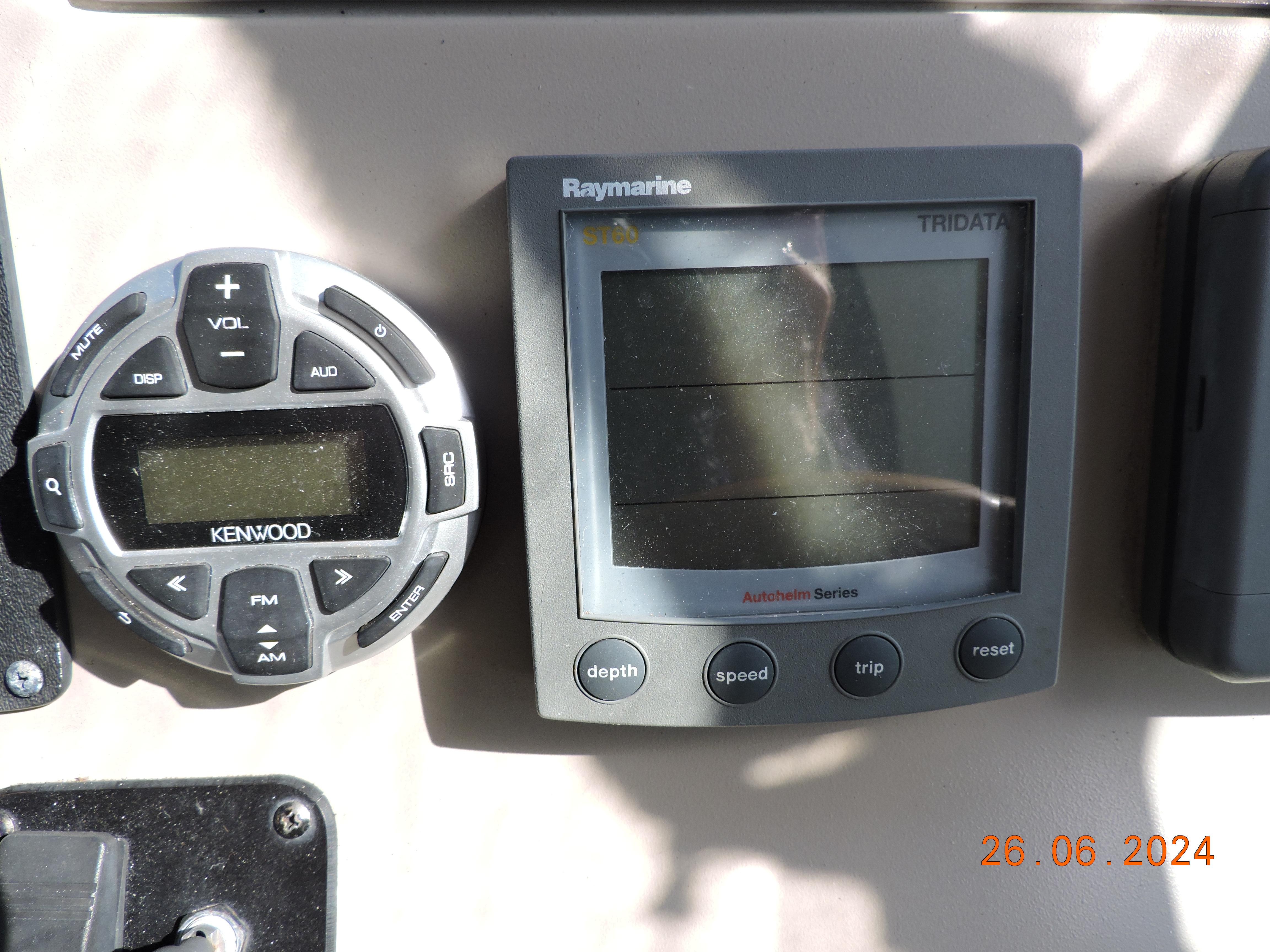 Kenwood and Raymarine displays on 2002 Sea Ray 310 Sundancer boat dashboard.