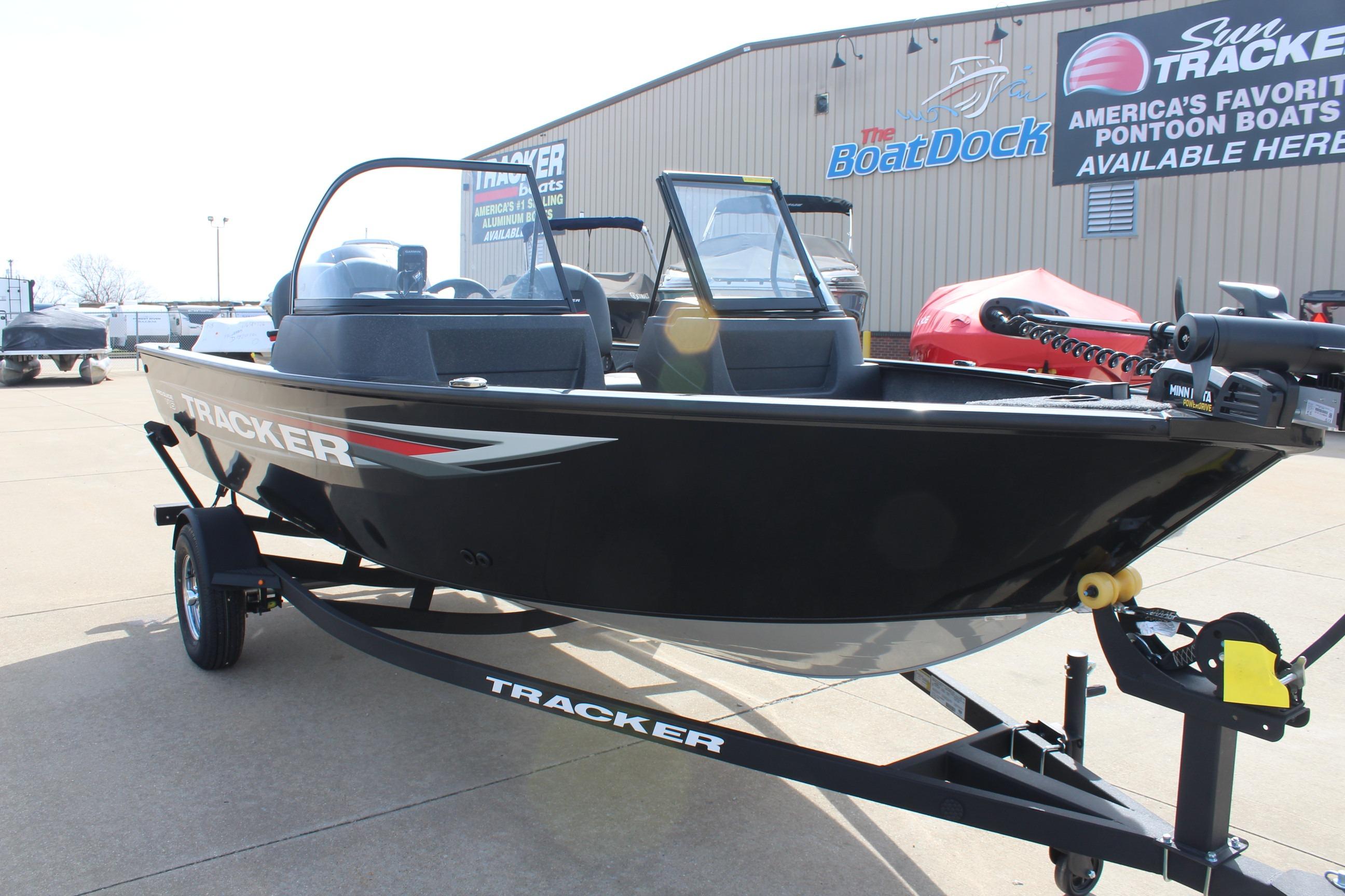 2026 Tracker Pro Guide V-16 WT boat on trailer at dealership.