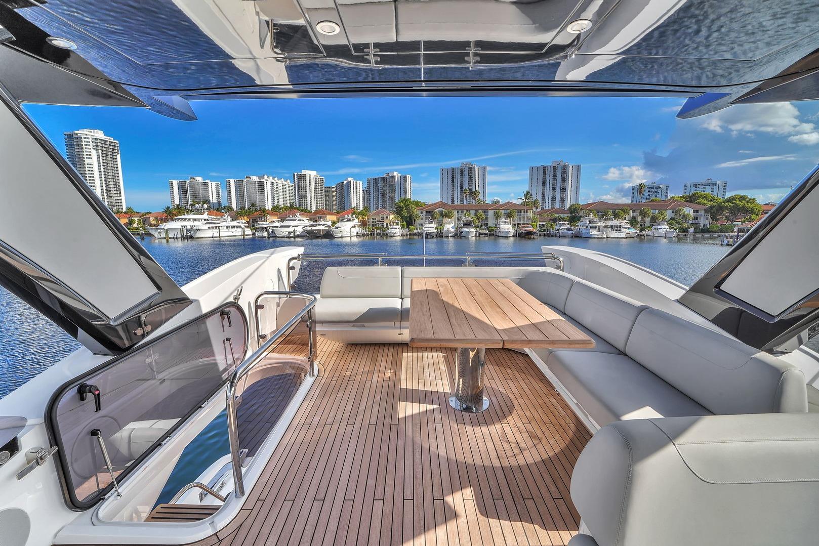 Luxurious Sunseeker Manhattan 68 yacht deck with city skyline view, 2023 model.