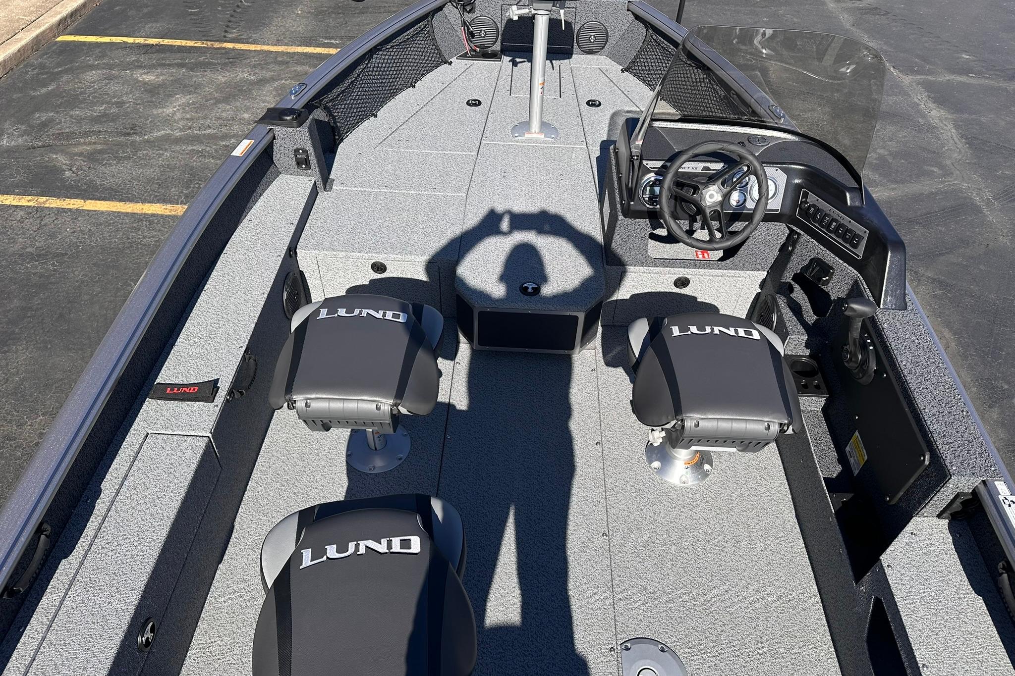 2026 Lund 1875 Impact XS SS boat interior with steering wheel and seating.