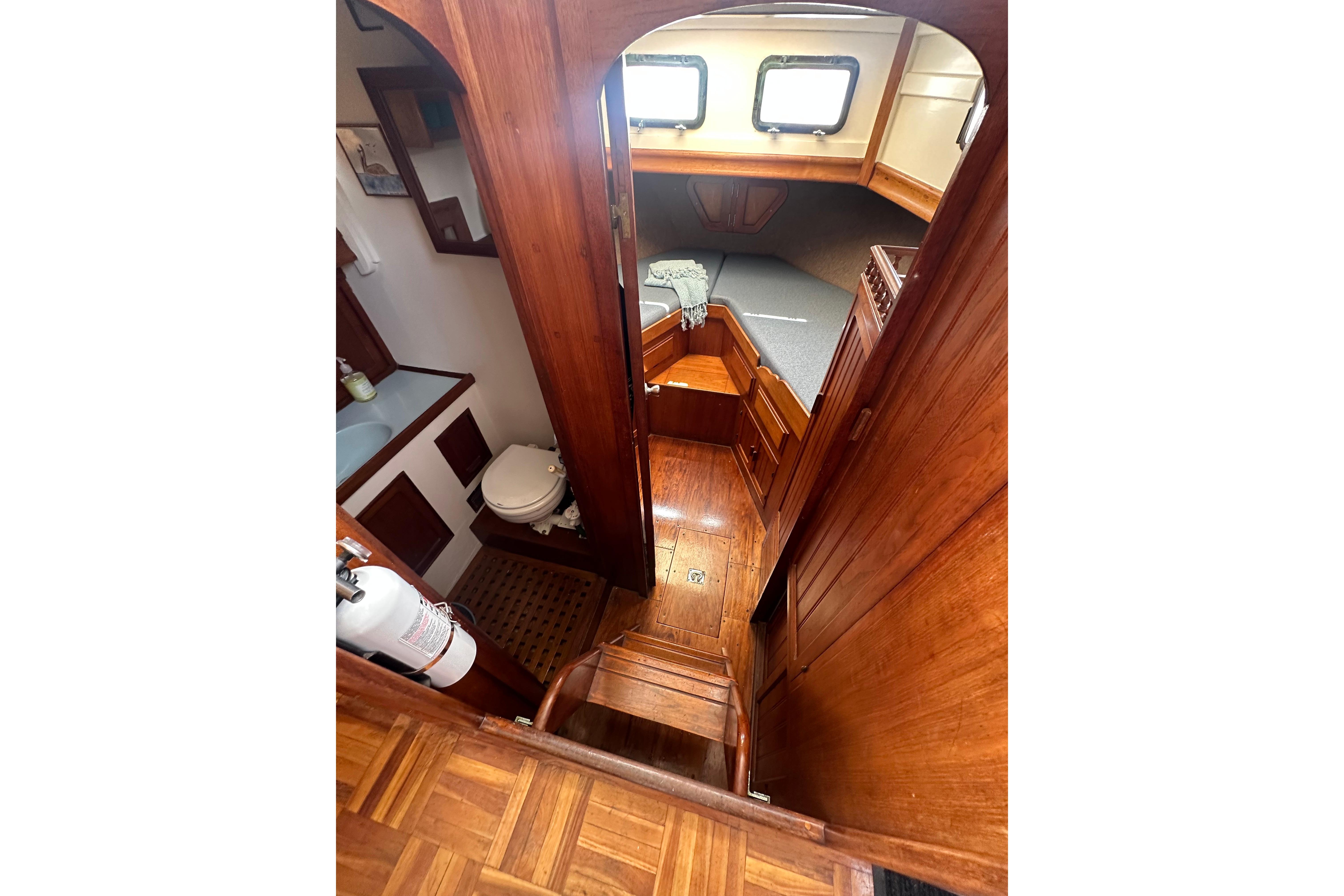Interior of 1973 CHB 33 boat with wooden finish, showing cabin and bathroom.