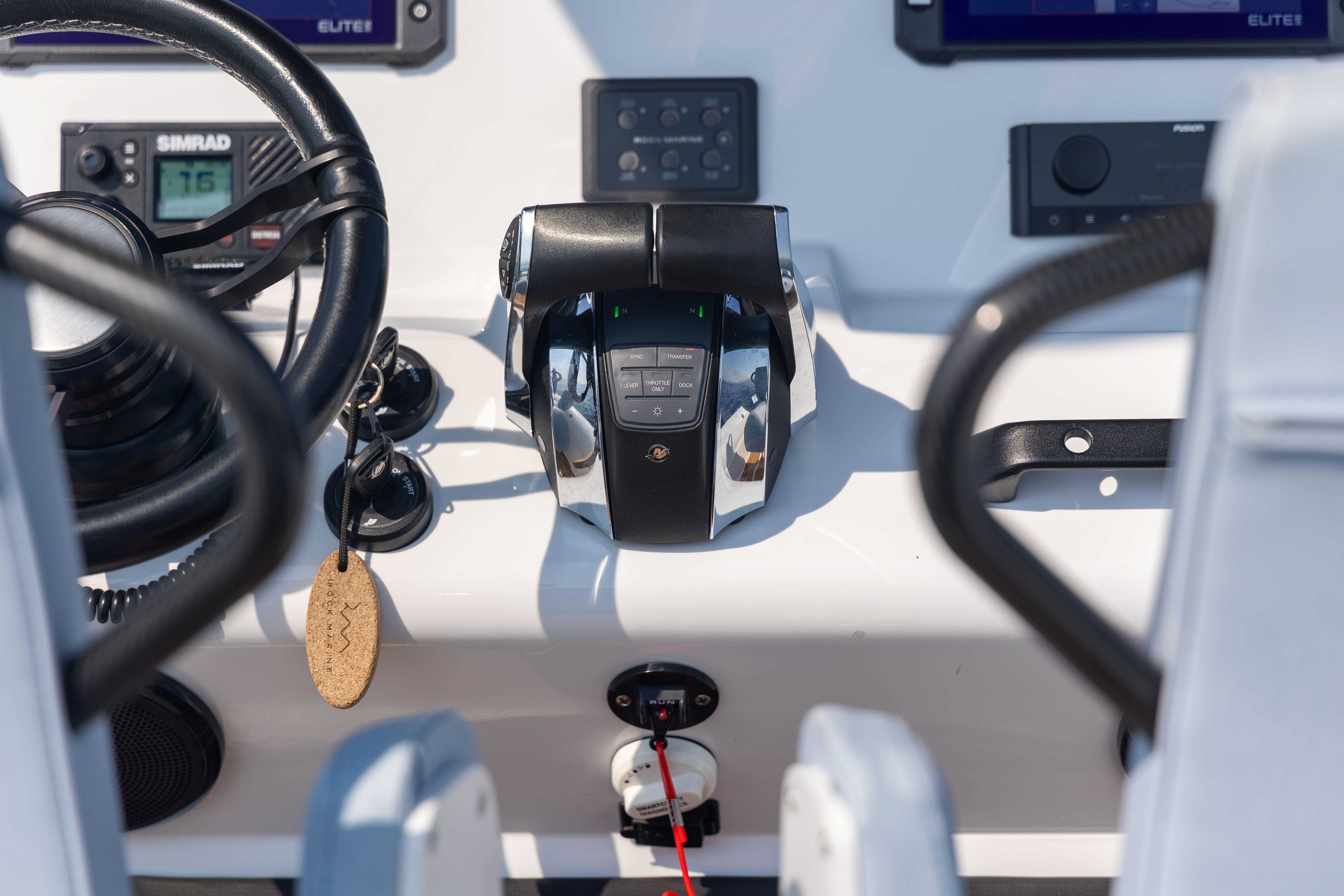 Control panel of 2026 Rock Marine RM 30 boat with steering wheel and throttle.