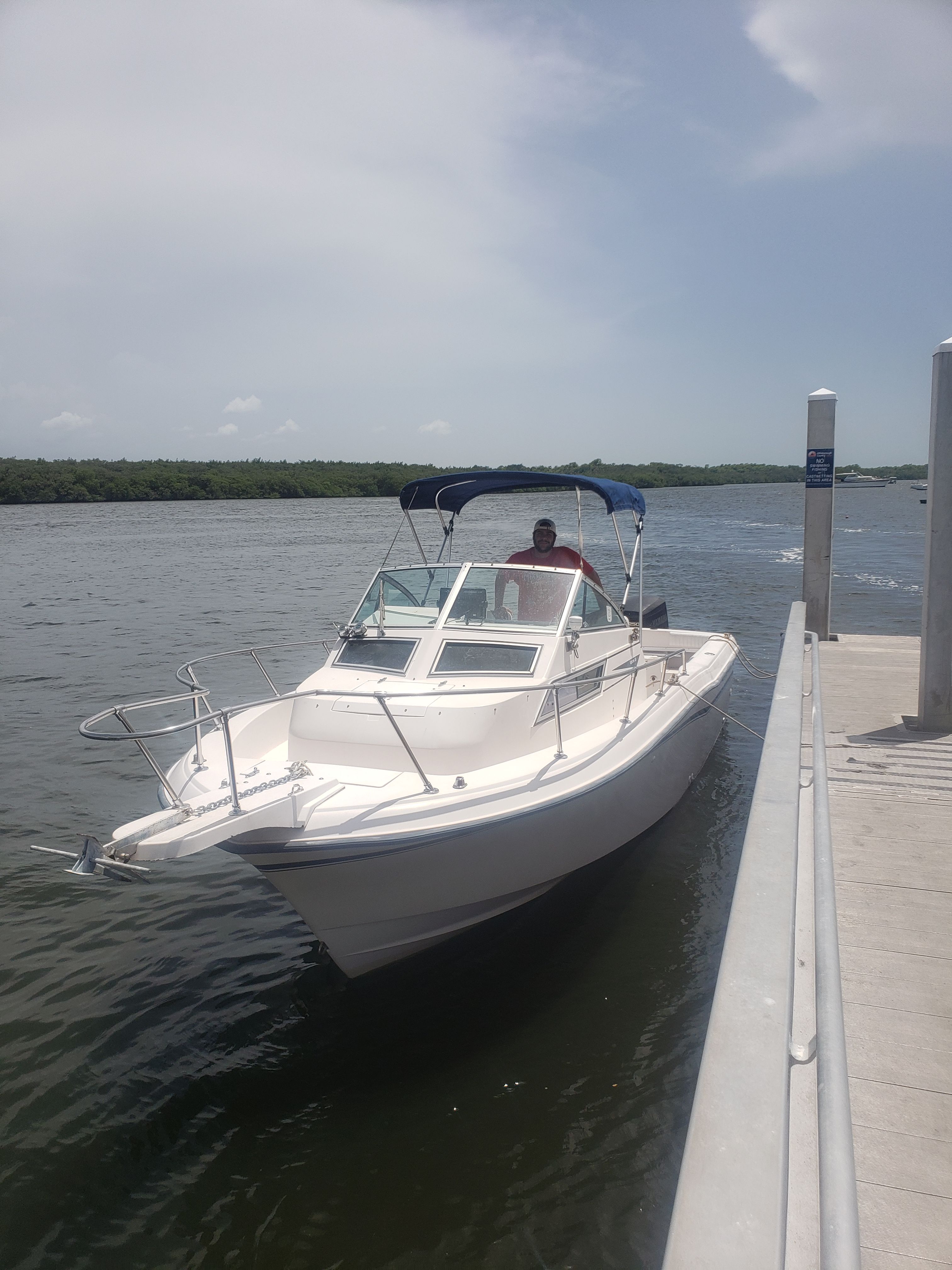 A 1995 Grady-White Explorer 24 is docked on a sunny day.