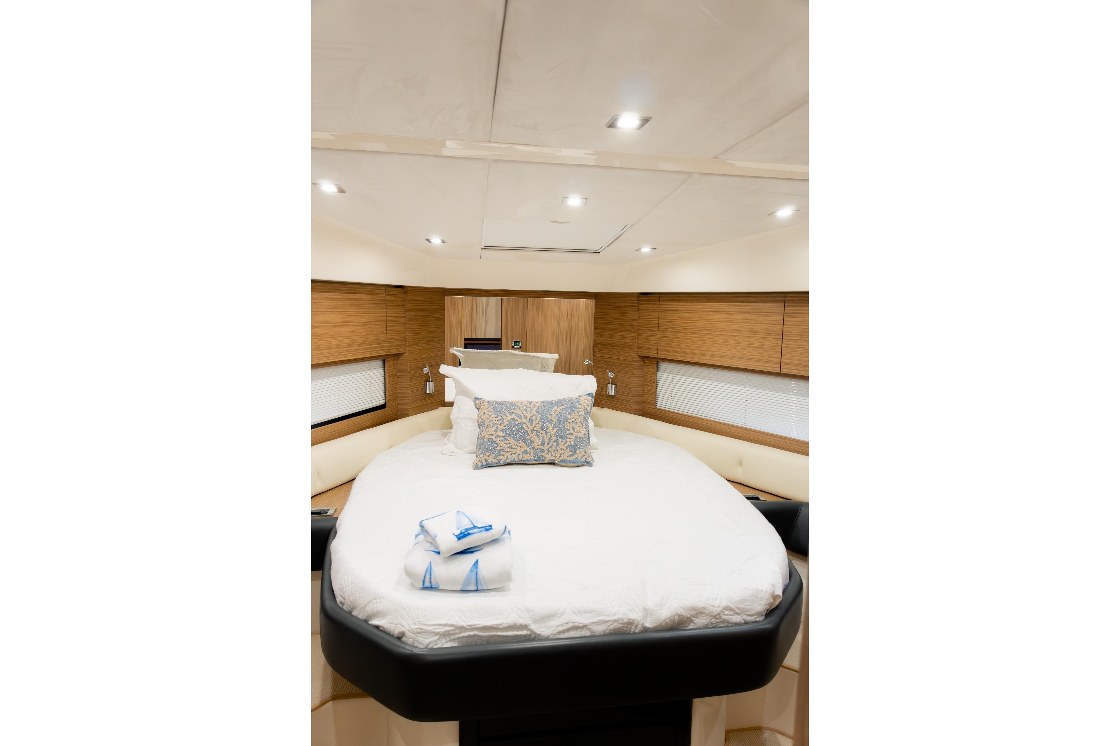Luxurious cabin interior of 2013 Azimut Atlantis 48 yacht with elegant bedding.