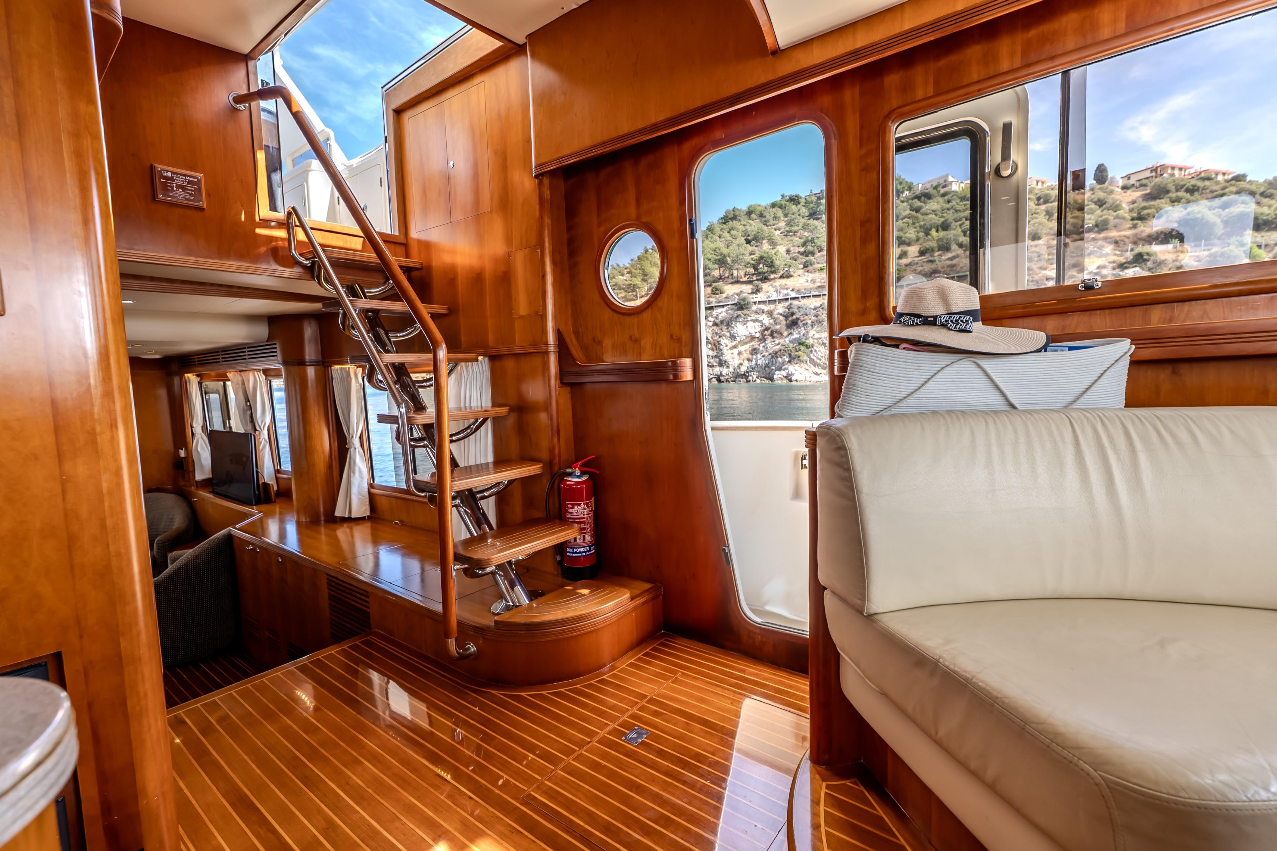 Luxurious 2004 Selene 62 yacht interior with wooden finishes and comfortable seating.