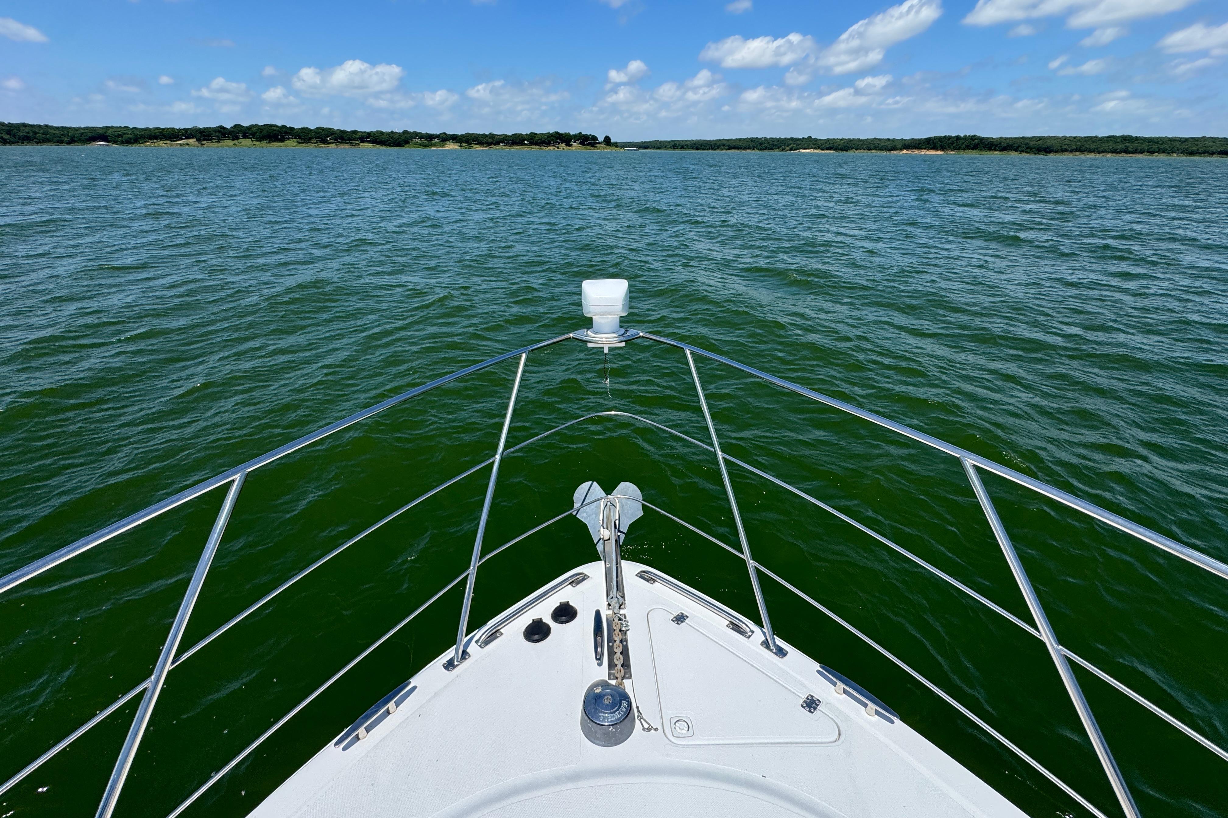 Bow view of 2002 Carver 396 Motor Yacht on a sunny day at sea.