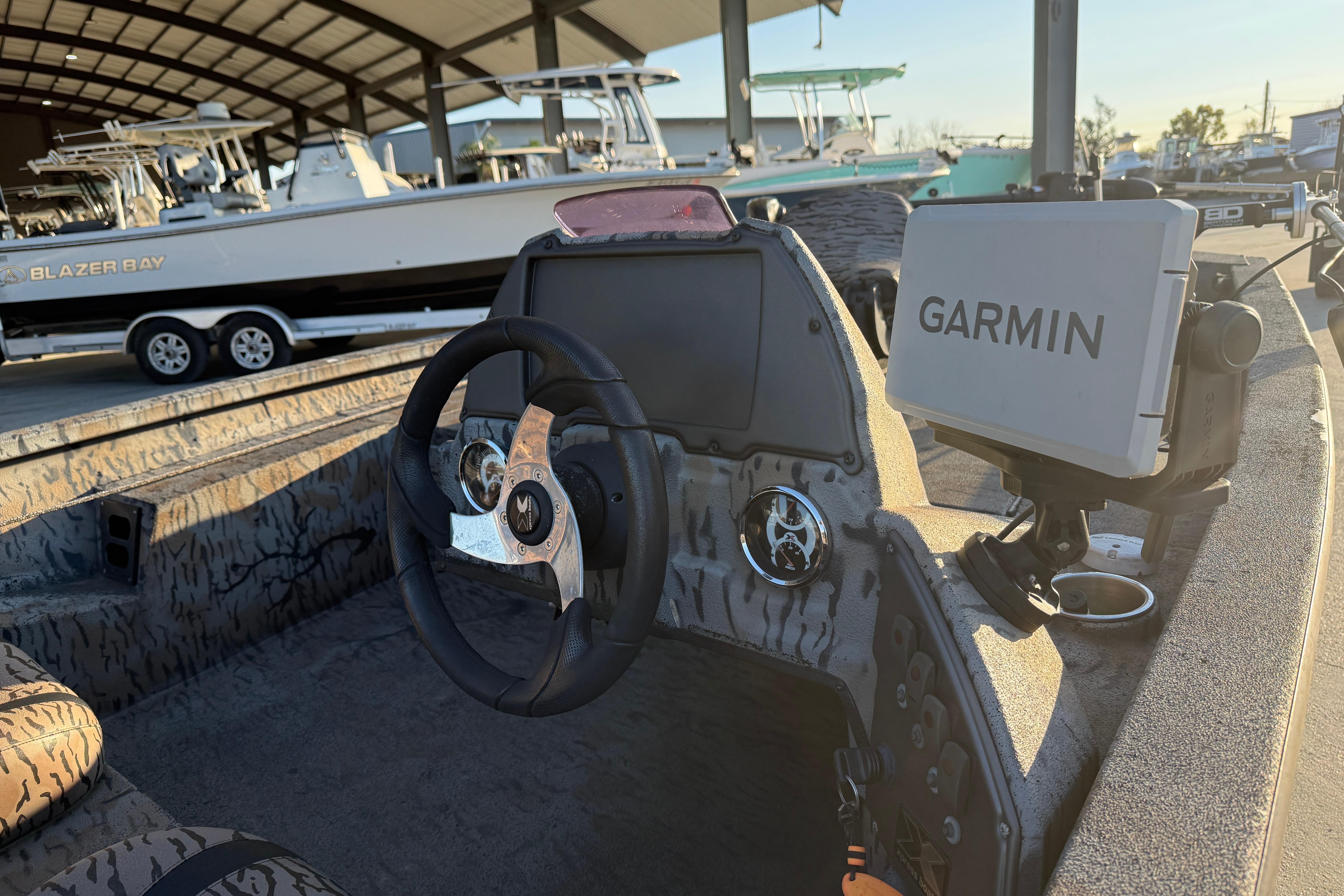 2019 Xpress XP7 boat interior with Garmin navigation system and steering wheel.