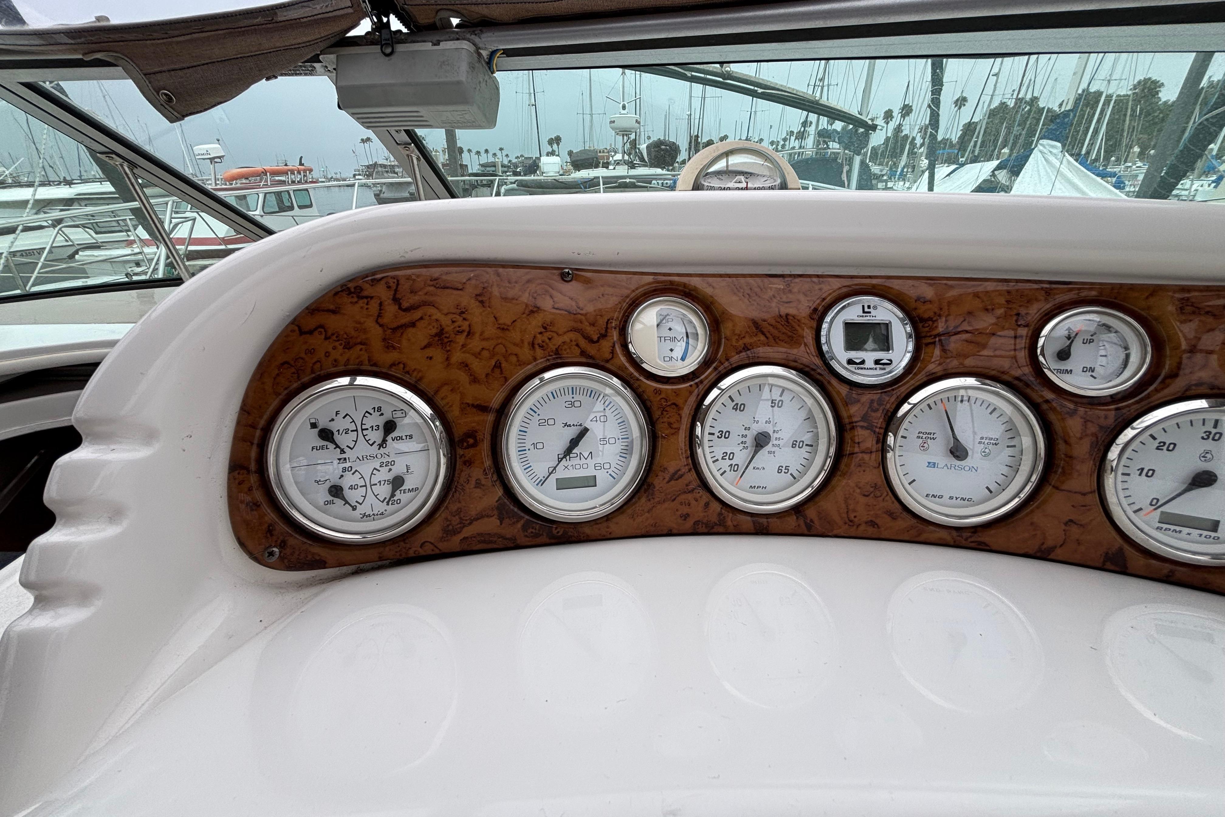 Dashboard of a 2004 Larson 310 boat with various gauges and controls.
