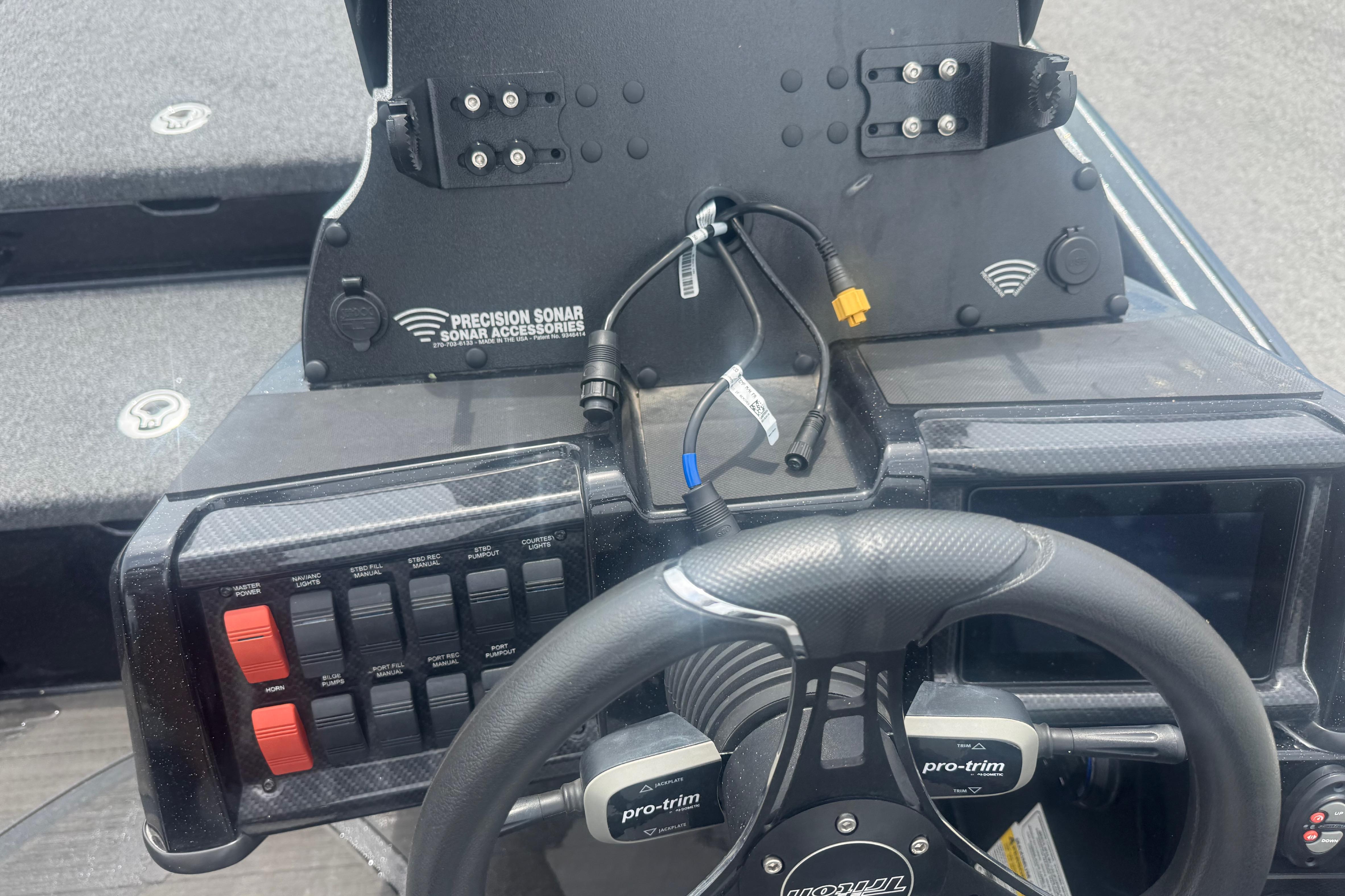 2024 Triton 20XP boat dashboard with steering wheel and sonar accessories.