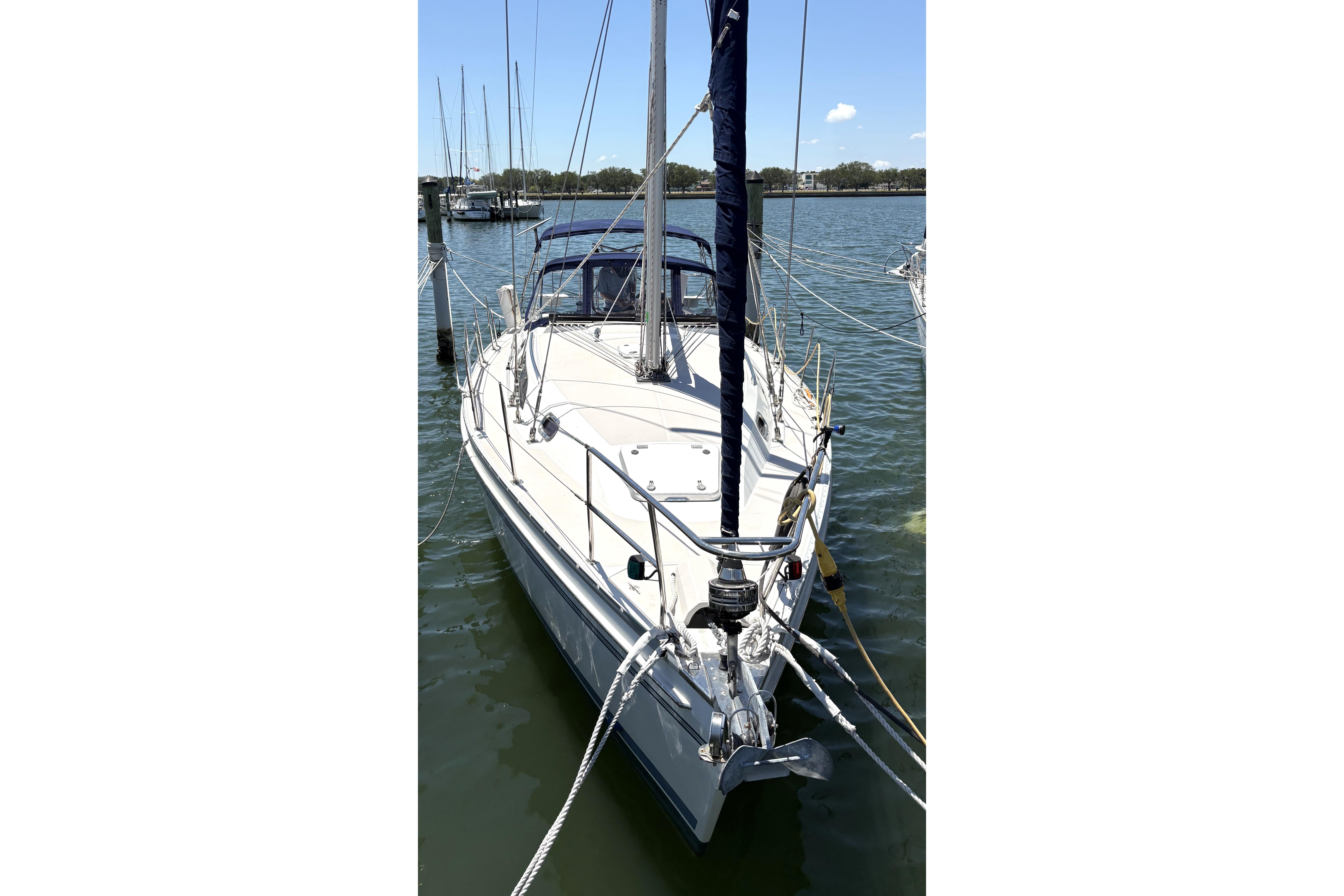 2011 Catalina 355 sailboat docked in a marina, clear sky background.