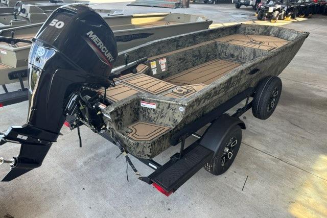 2026 Tracker Grizzly 1650 T Prairie Wings Edition boat with Mercury engine on trailer.