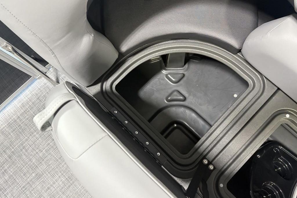 2026 Sun Tracker PARTY BARGE® 20 DLX storage compartment with gray seating.