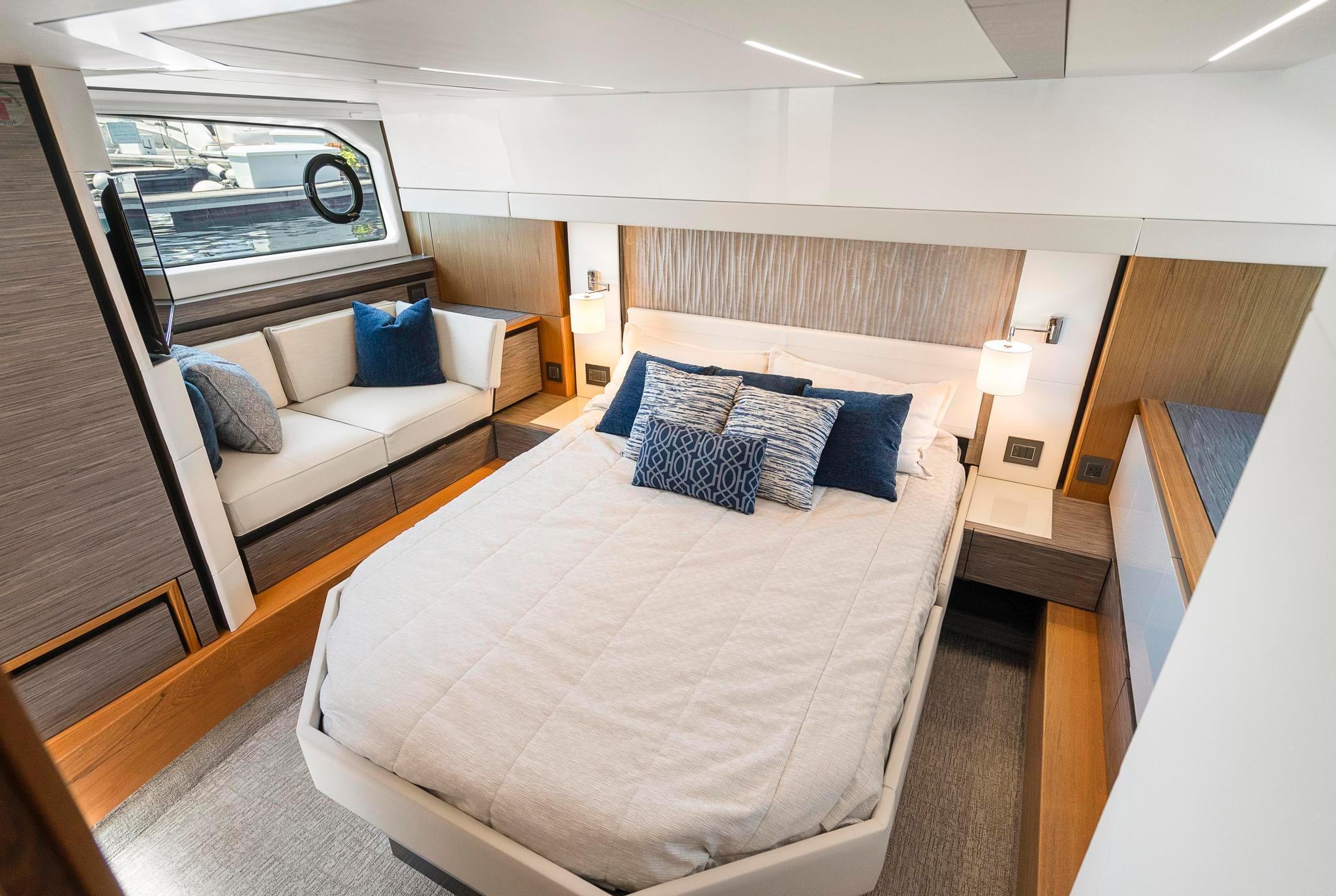 Luxurious bedroom interior of 2022 Tiara Yachts C49 Coupe with modern design and cozy seating.