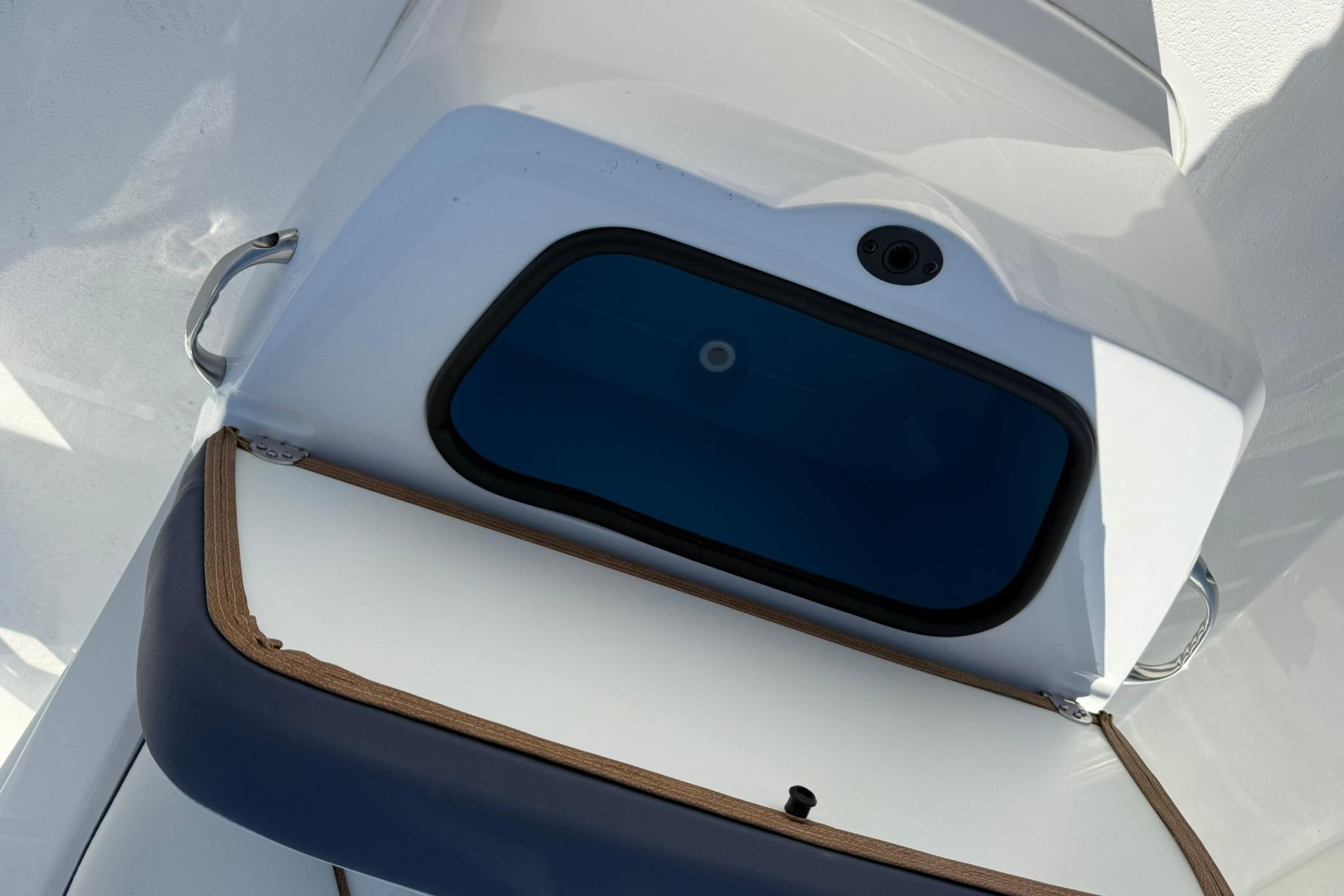 Open storage compartment on 2026 Stingray 173 CC boat, featuring sleek design and blue interior.